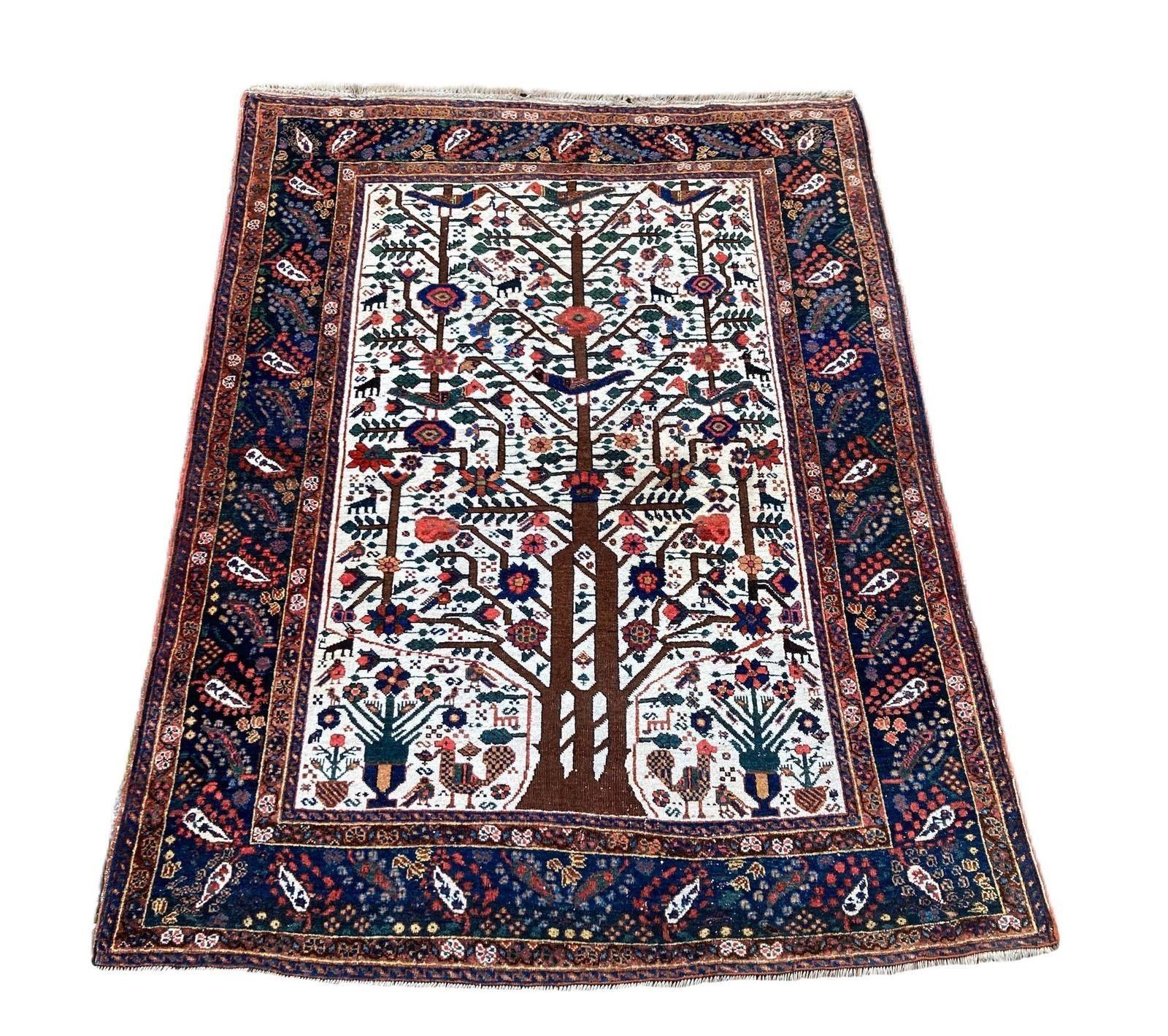A beautiful antique Neyriz rug, handwoven circa 1910 with a Tree of Life design interspersed with stylised birds and animals on an ivory field and indigo border. Fabulous secondary colours and a great example of tribal weaving.
Size: 2.02m x 1.54m