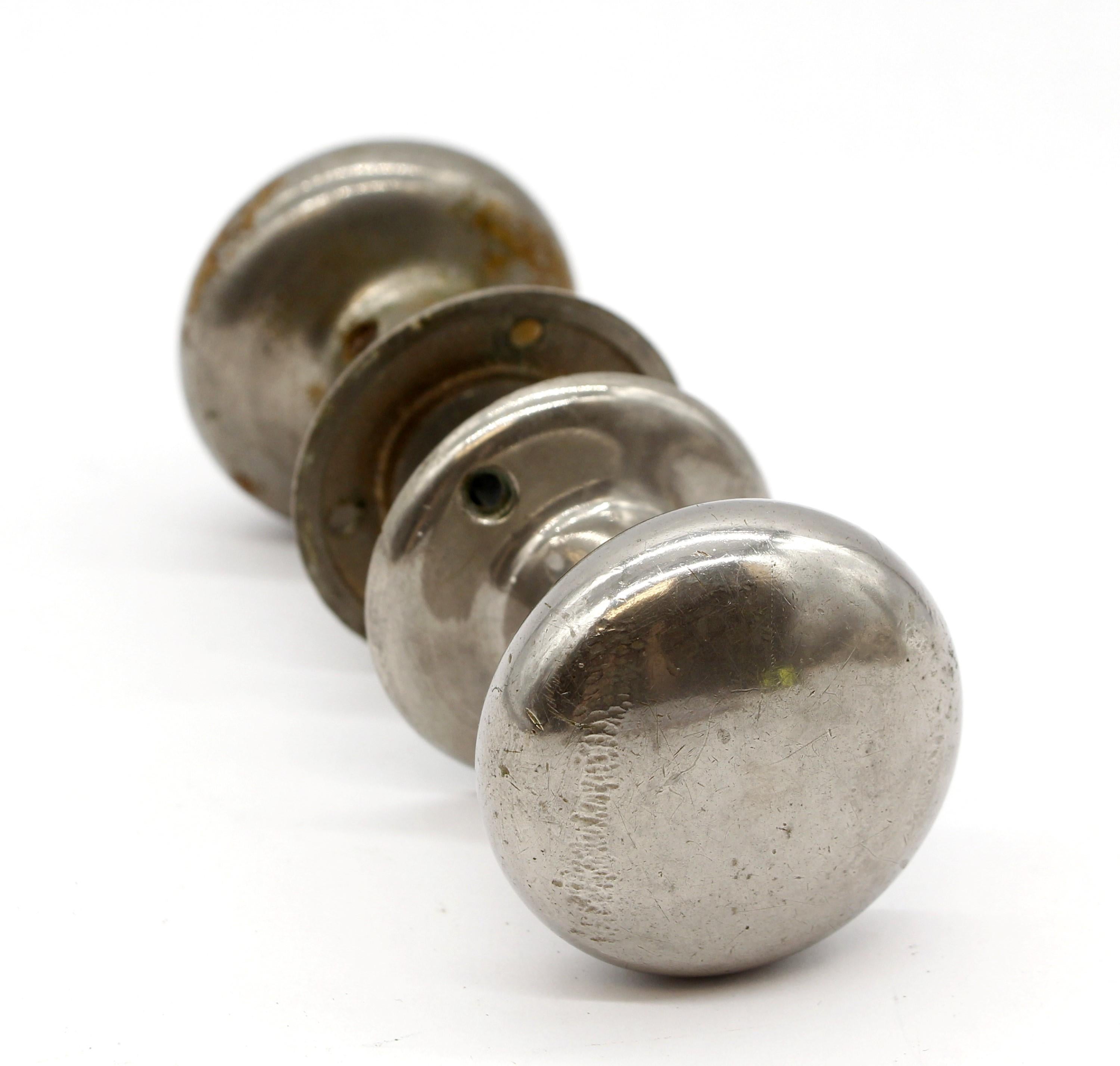 Solid nickel-plated brass doorknob set with matching heavy rosettes. There is some wear with the nickel plating due to age and use. Small quantity available at time of posting. Priced each. Please inquire. Please note, this item is located in our