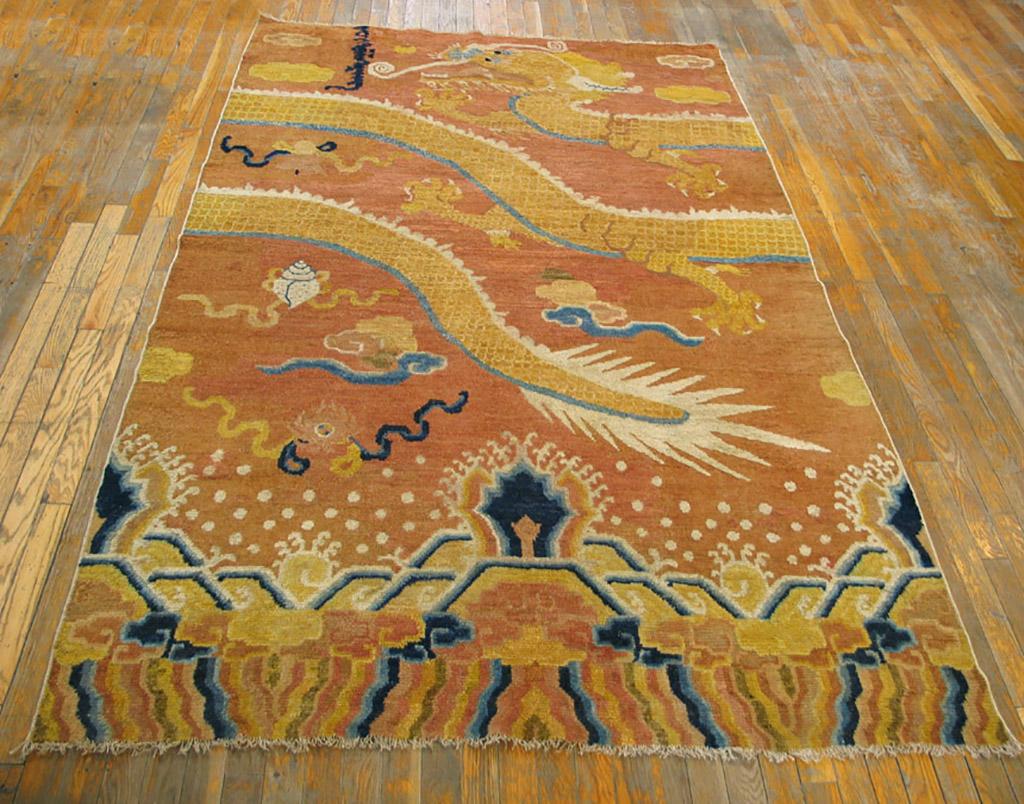 Ningxia in Northern China provided Tibetan monasteries with large numbers of pillar carpets with wraparound dragons soaring above mountains and waves, usually, as here, with originally red, now faded to rich gold, backgrounds. Although reduced at