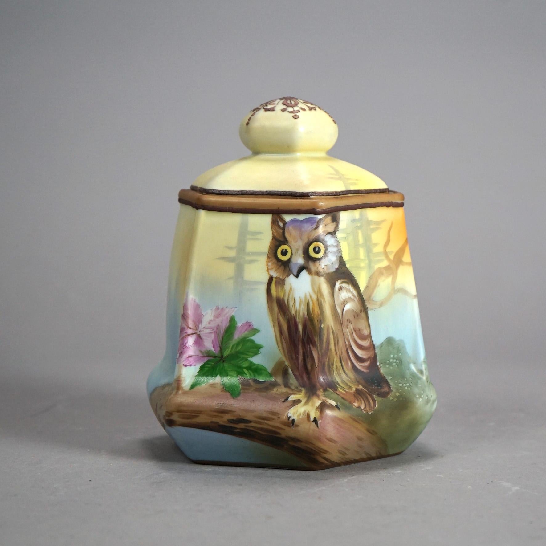 An antique Japanese Nippon figural lidded humidor offers porcelain construction in hexagonal form with hand painted owl in countryside setting; c1920

Measures - 7