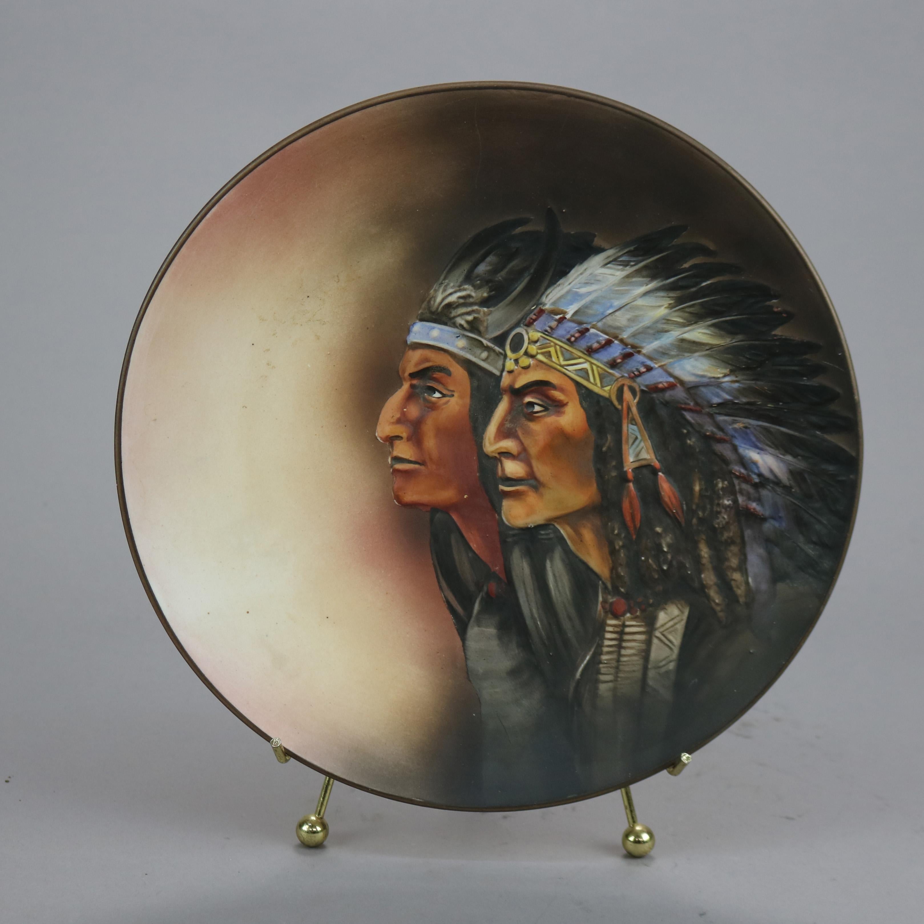 An antique Japanese Nippon plate offers hand painted double portrait of Native American Indians in relief, mark on base as photographed, c1930

Measures - 1.25'' H x 10.75'' W x 10.75'' D.