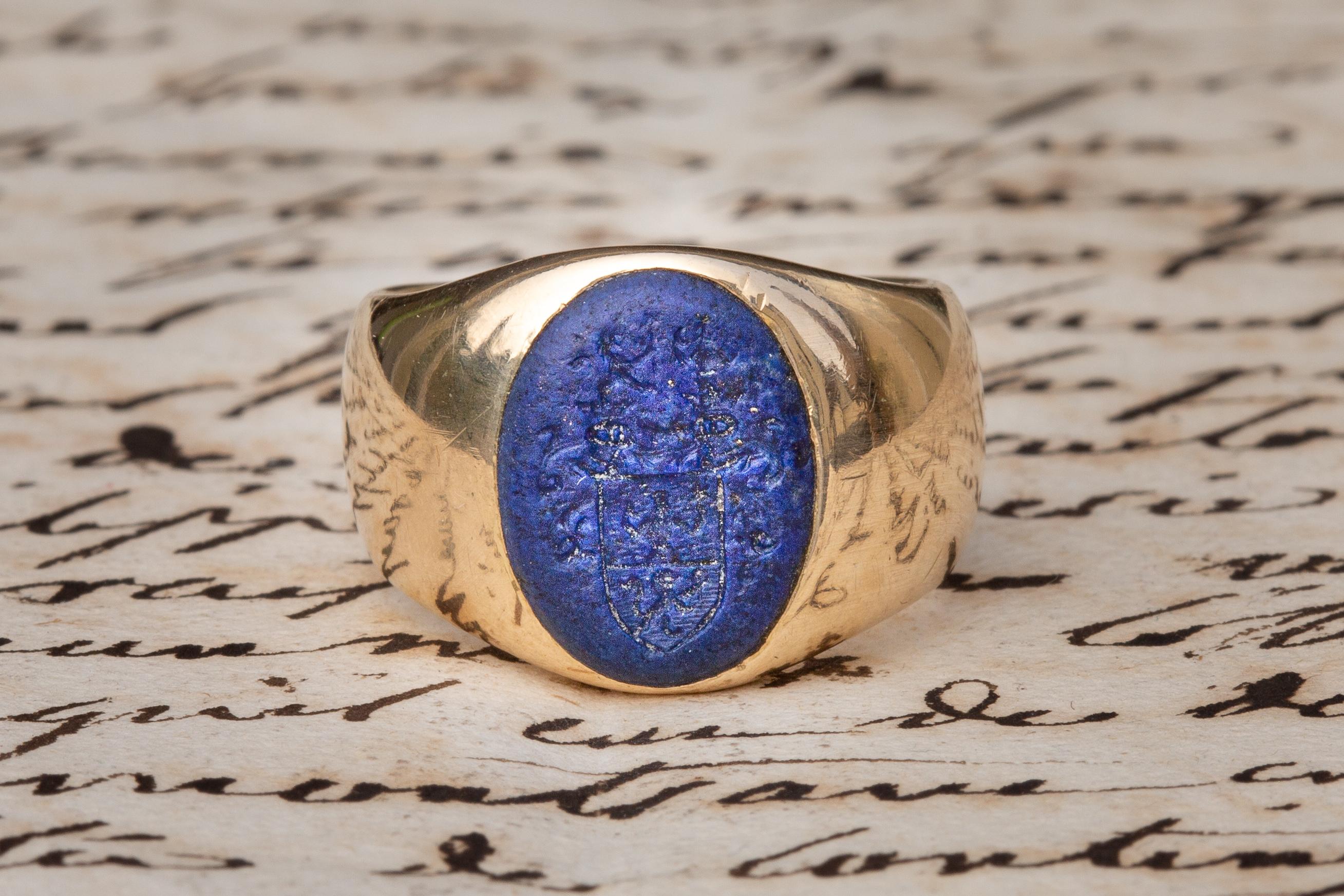 This fantastic heavy gold signet ring dates to the 1880's and was made in Austria. A vibrant lapis lazuli is engraved with a heraldic Romanian family coat of arms. These arms belong to the Ritter von Tabora family, Romanian nobles from Bukovina