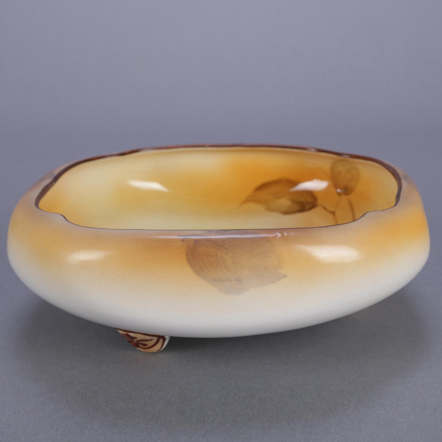 An antique Noritake Nippon porcelain blown-out bowl features hand painted foliate and nut design and raised on scroll feet, en verso Noritake stamp, 19th century


Measures: 2.5