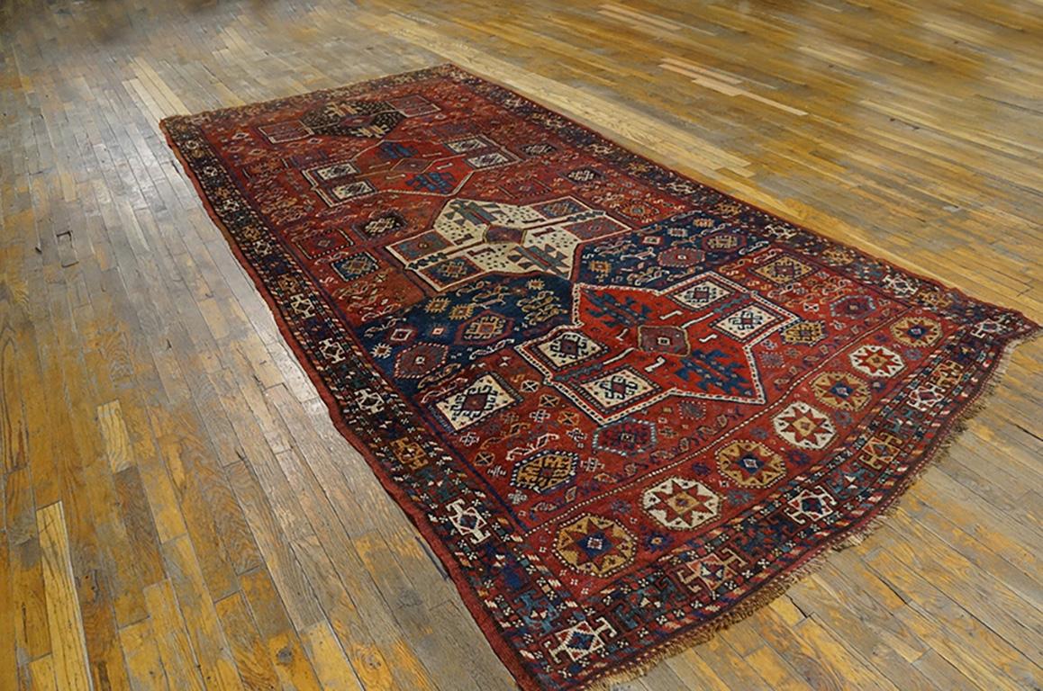 The Kurdish tribes of northeastern Persia weave a unique style of carpets, colorful and geometric, with particularly warm, mellow reds and yellows. Here four medallions in bright reds, ivory and aubergine stand out against a scatter of small