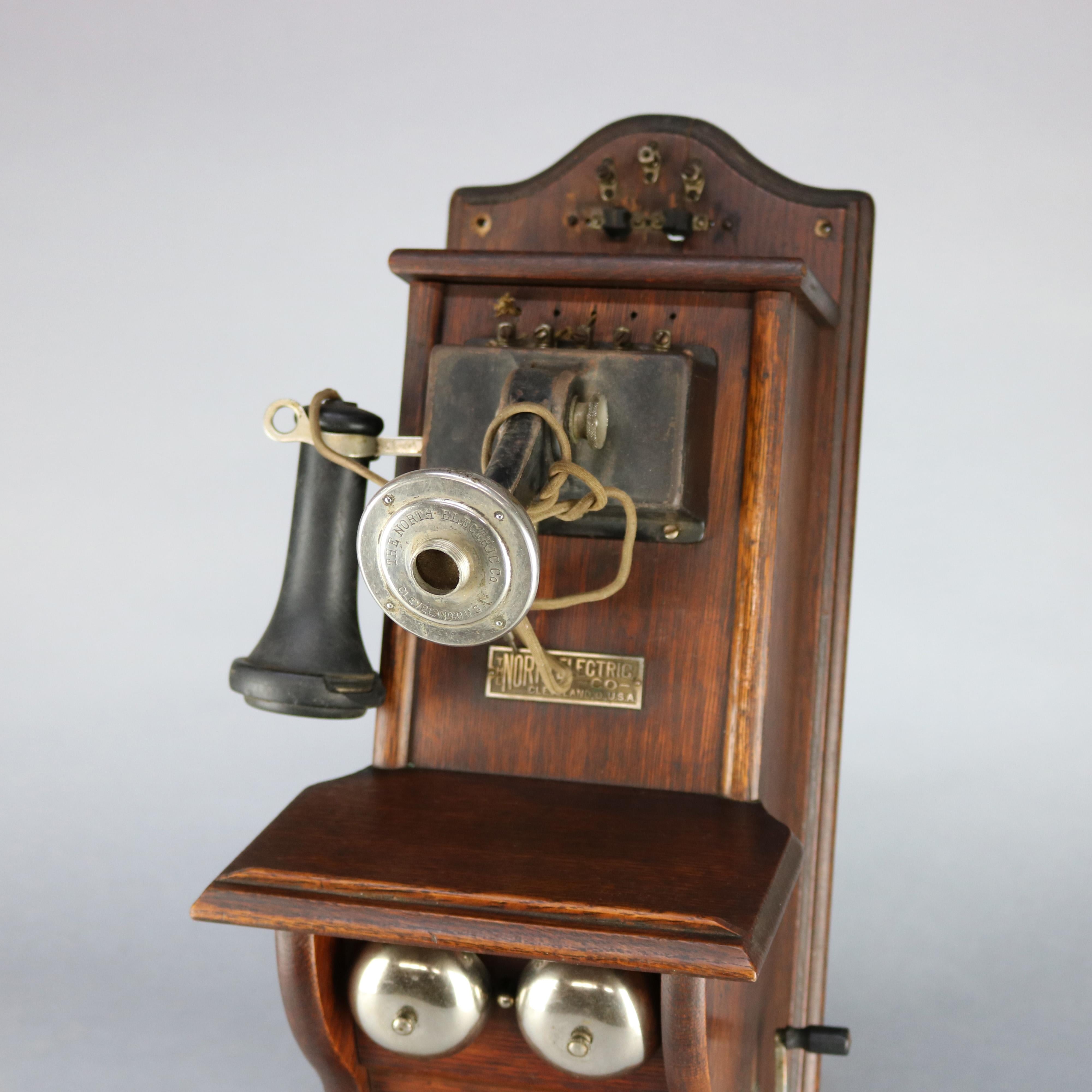 An antique paddle type wall telephone by North Electric offers oak case with original hardware and label as photographed, circa 1890.

Measures: 25