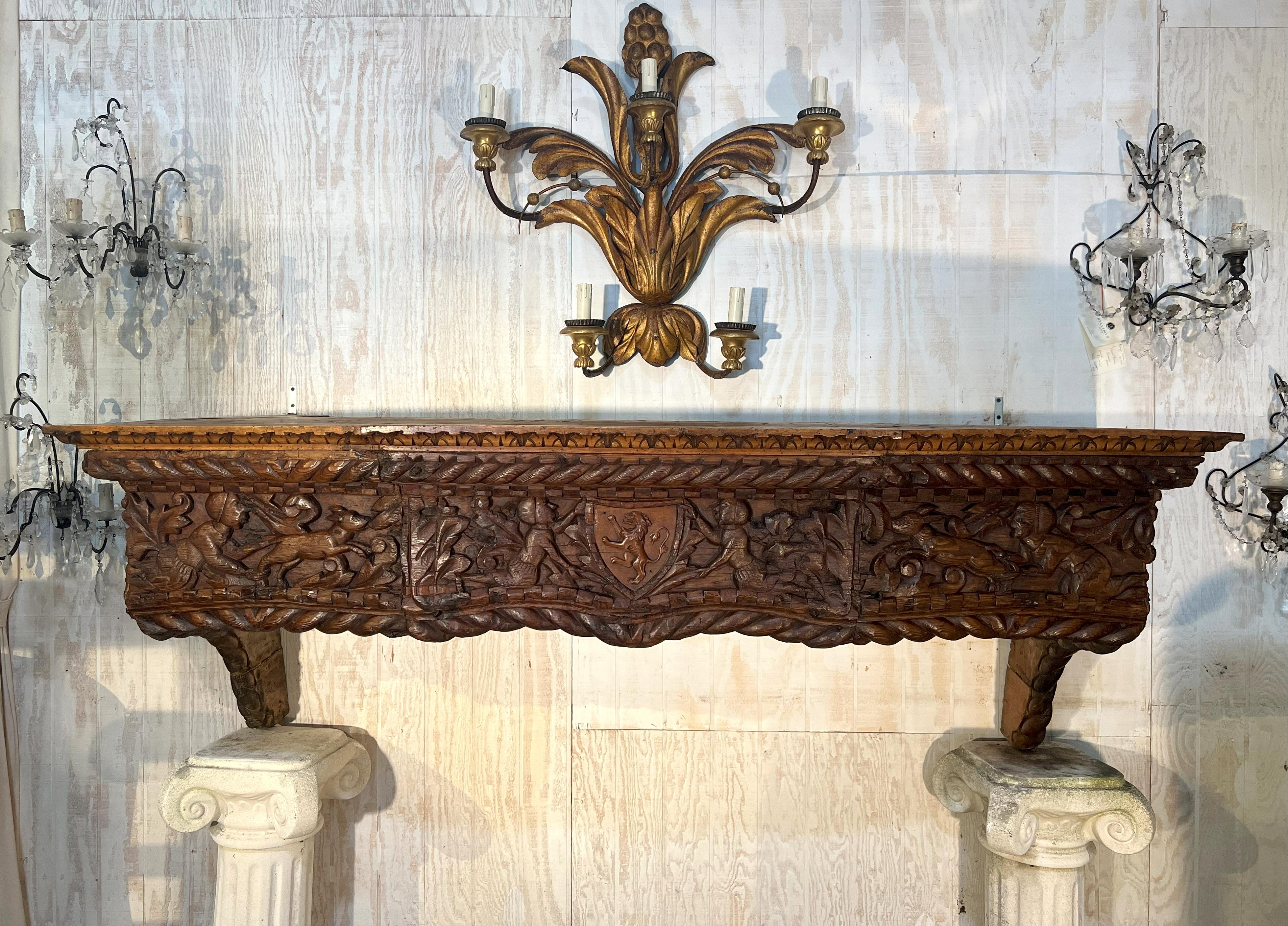Great Antique North Italian heavy hand carved chestnut fire place mantel. 
Carved on each of the sides there are two Renaissance dragons with snake-scaled body. In the left and right front panel two hunting scenes with dogs and in the center panel