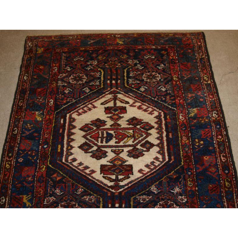 Antique North Persian Kurdish runner with repeat medallion design.

A good Kurdish runner with linked medallions in ivory and madder red on a dark indigo ground.

Excellent condition with slight even wear and good pile.

Ideal runner for