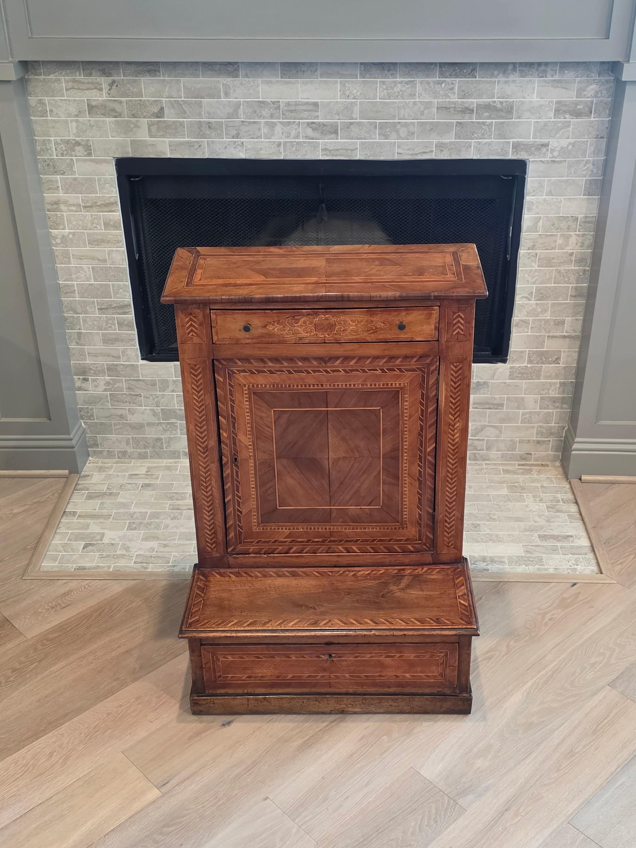 XIX secolo, regione lombarda dell'Italia settentrionale, probabilmente Milano, con una lavorazione artigianale di alta qualità, una struttura in legno massiccio e intarsi, parquet e fasce. 

Questo scarso inginocchiatoio da tavolo per la preghiera