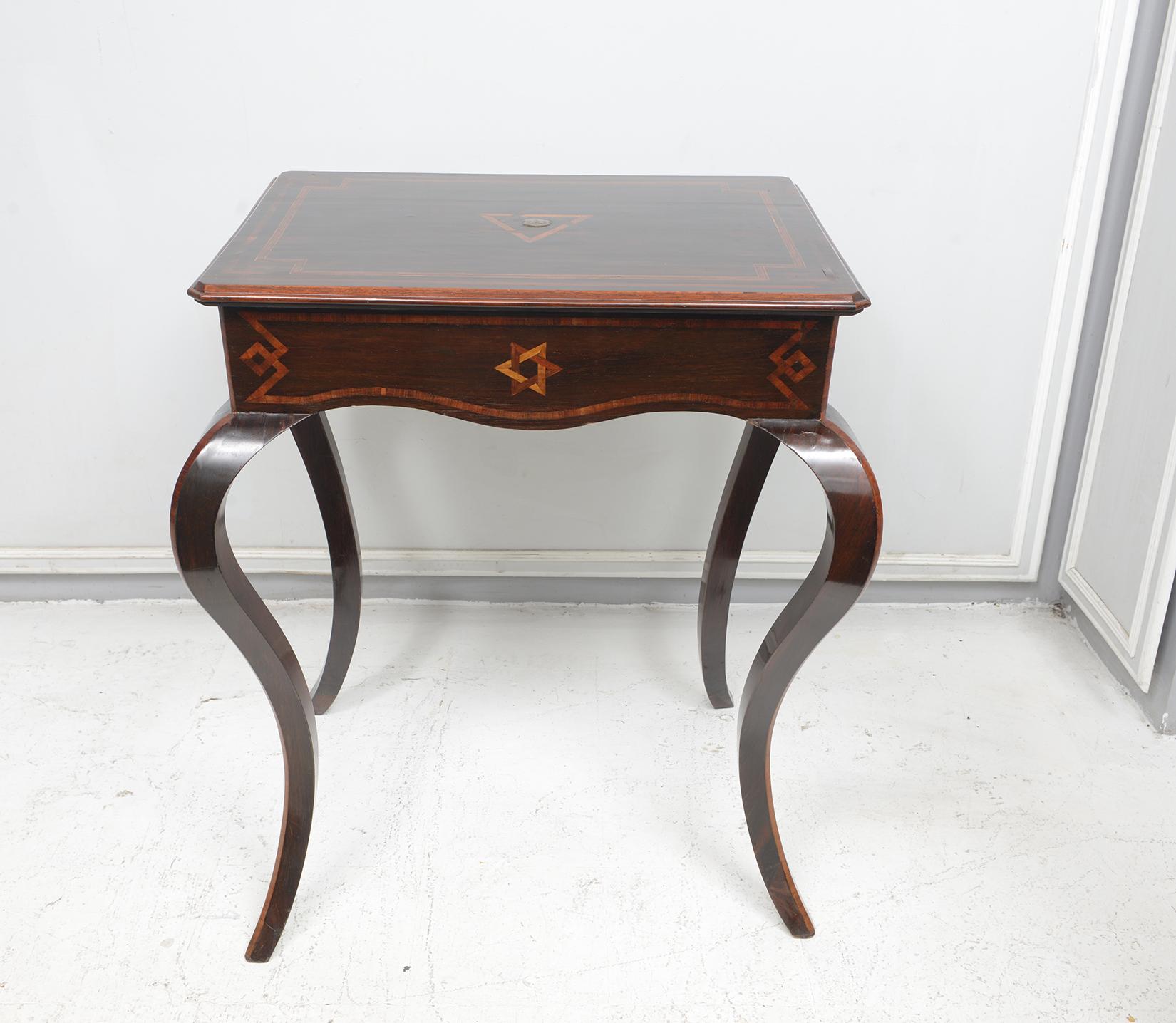 Antique Northern Italian table on Sabre legs. 
Table is handcrafted of rosewood with different types of wood: rosewood, mahogany and satinwood inlay.

