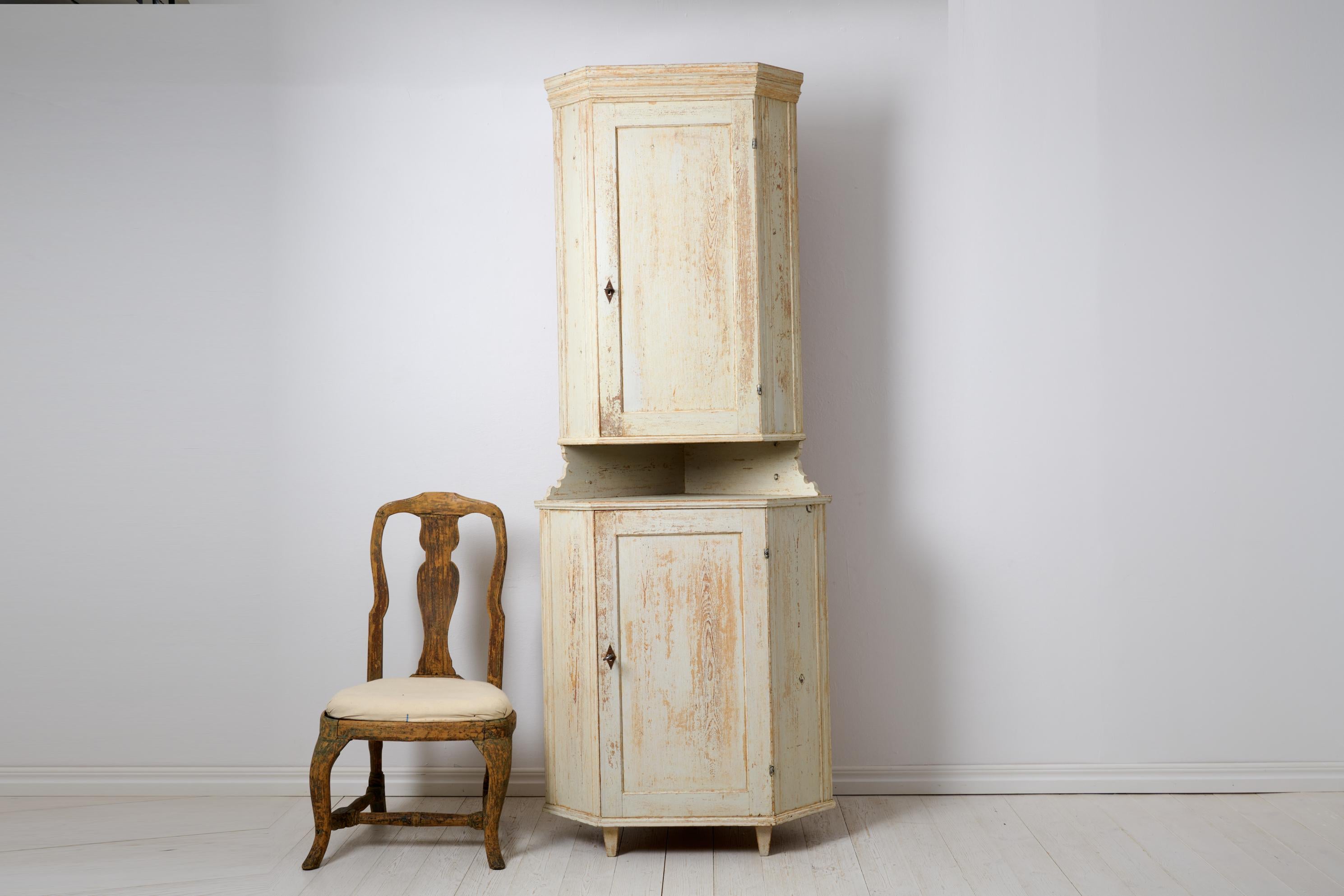Antique country corner cabinet in gustavian style from northern Sweden. The cabinet is made around the 1820s by hand in solid pine. It’s made in two parts with a detachable mid section – see picture. Straight classic shape, healthy and solid frame.