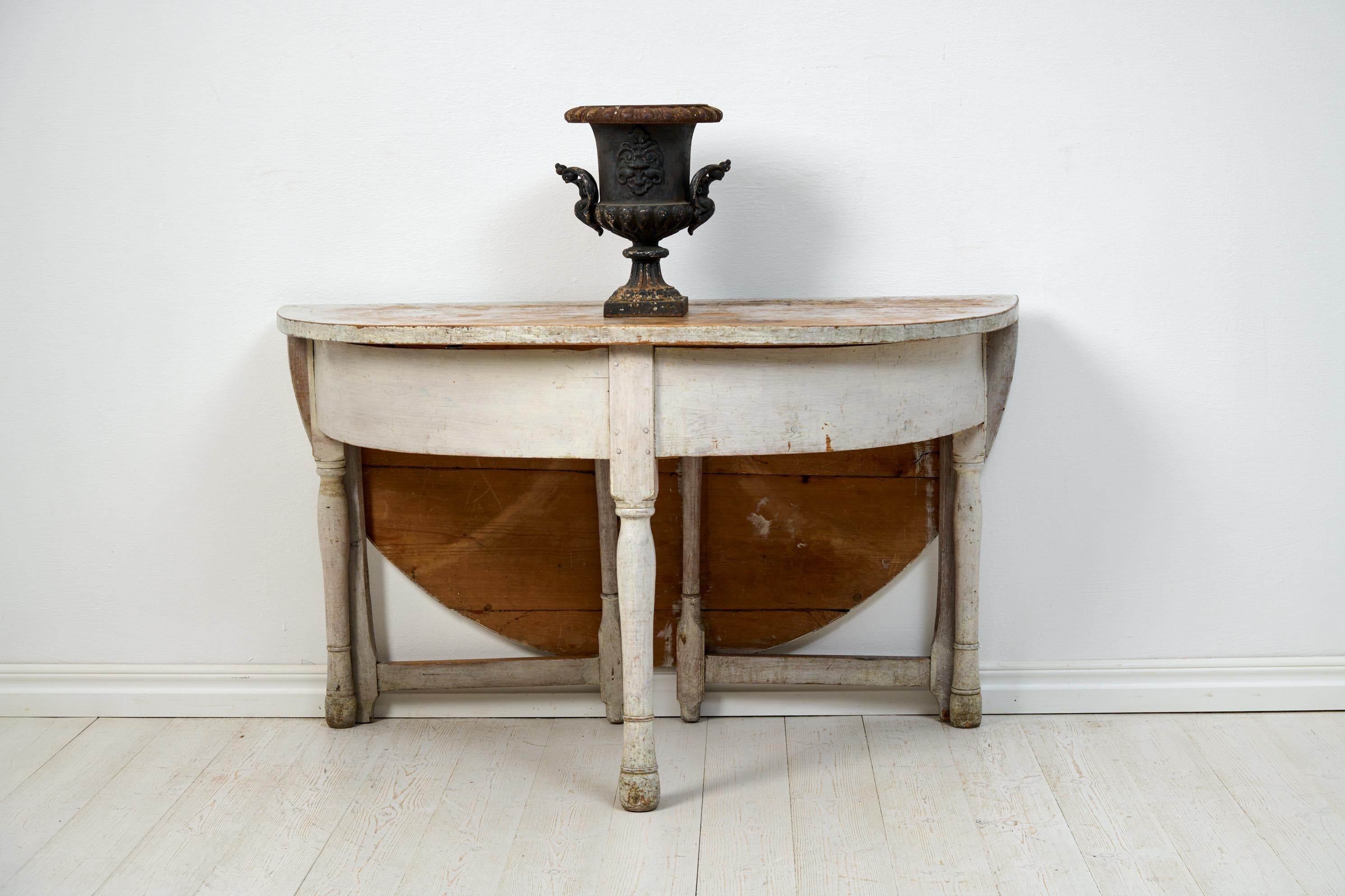 Antique Swedish console table from the early 1800s, circa 1810 to 1820. The table is handcrafted in solid pine and remains in untouched condition with its original first paint. The paint and surface has some distress, as well as marks and traces