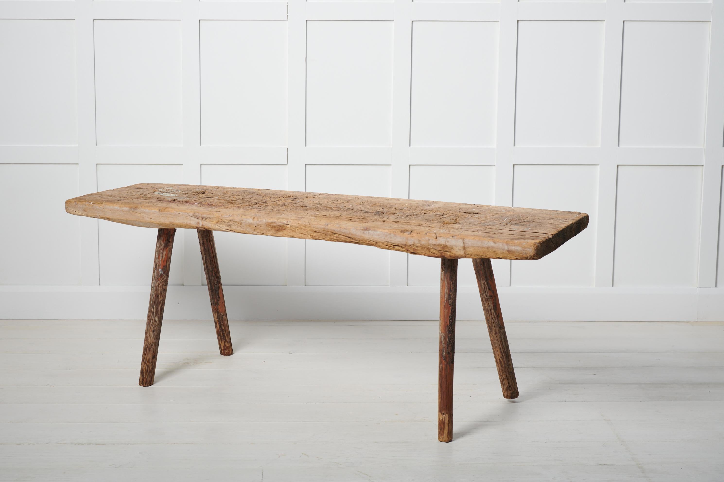 Antique primitive Swedish bench in folk art from northern Sweden. The bench is made during the first few years of the 19th century, around 1810 to 1820. The bench is one of the simplest and purest forms of seating. A wooden board with four legs made