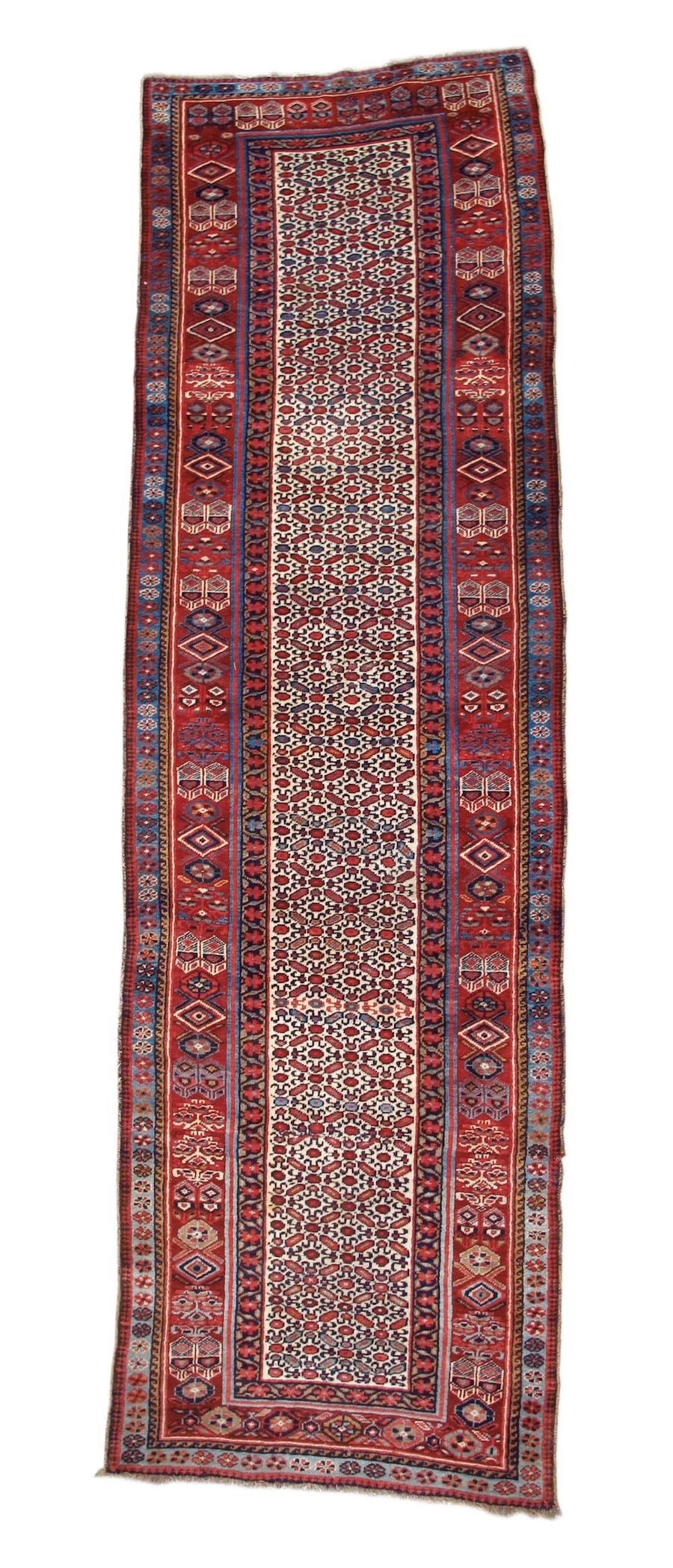 Antique Northwest Persian Long Runner Rug, 19th Century

Woven with a white field using an over-all repeat lattice, this Northwest Persian runner almost looks like a large saddle-bag— drawing on the rich color and distinctive patterns of Kurdish