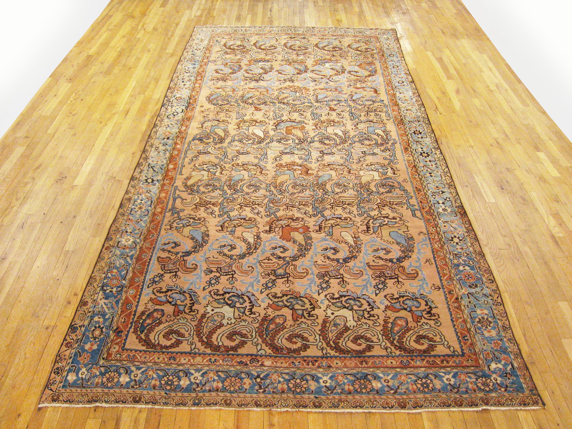 Antique Persian N. W. Persia rug, runner size, circa 1910

An antique N.W. Persia oriental rug in runner size, size 13'5 x 6'10, circa 1910. This handsome hand-made carpet features a Paisley design allover the rose central field. The field is