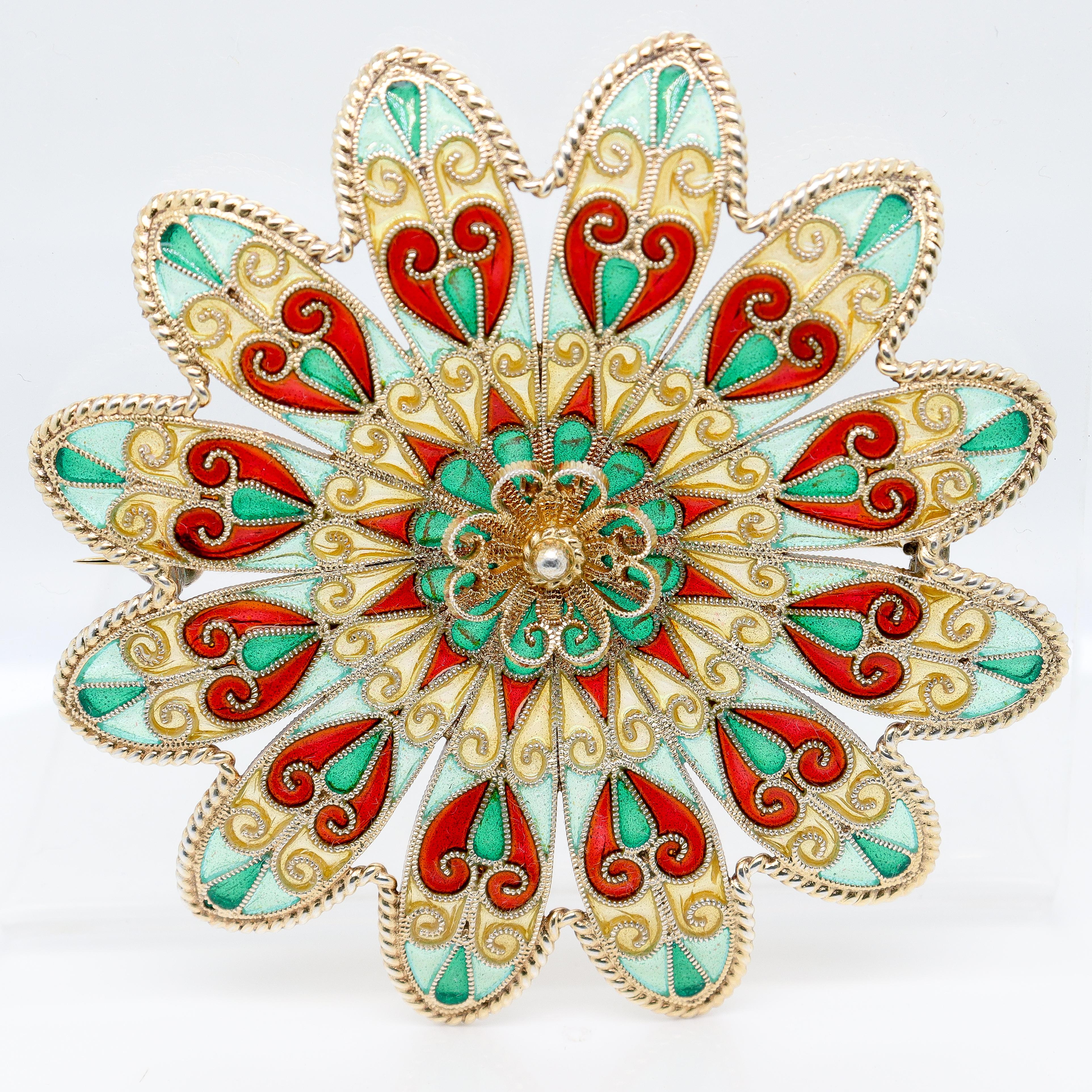 A fine antique signed Norwegian silver and enamel brooch. 

In the form of a flower in gilt sterling silver. 

With polychrome plique a jour enamel decoration throughout.

Marked to the reverse JGK for Johan G Kjaerland. He was apparently active