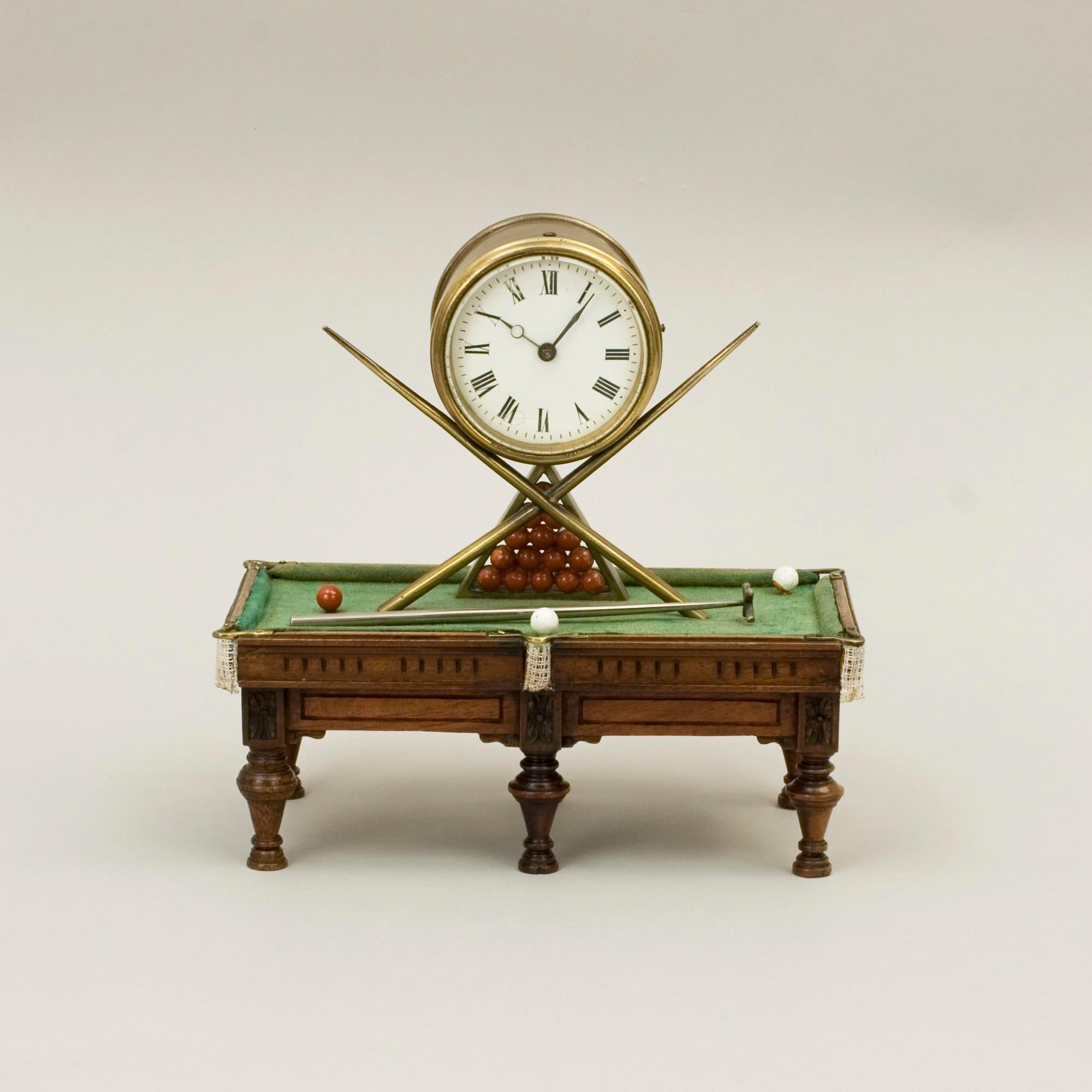 Novelty Billiard mantel clock.
A rare and very unusual novelty mantel clock, the base being a miniature billiard table. The drum-shaped clock case has a 6 cm porcelain dial fronting an eight-day spring-driven French movement supported on two