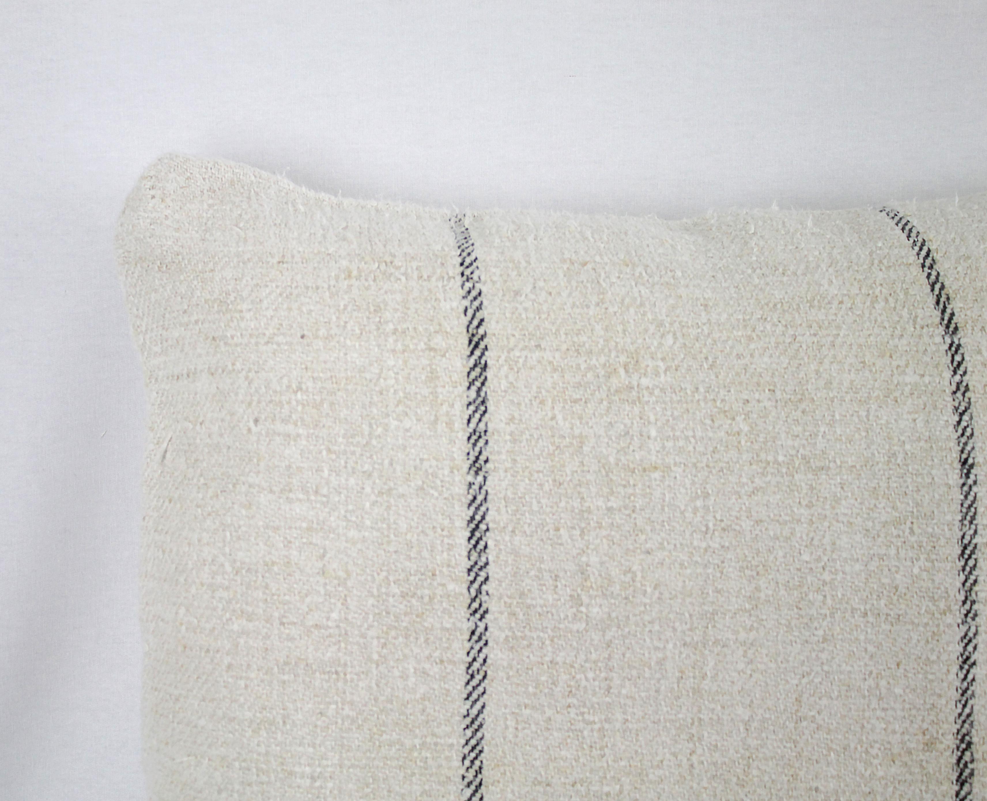 Beautiful pillow made from antique farmers grain sack, circa 1890-1920. These are a light oatmeal color with two small black stripes in the centre. Each pillow is finished with a zipper closure. Front and back are in the same grain sack, and both