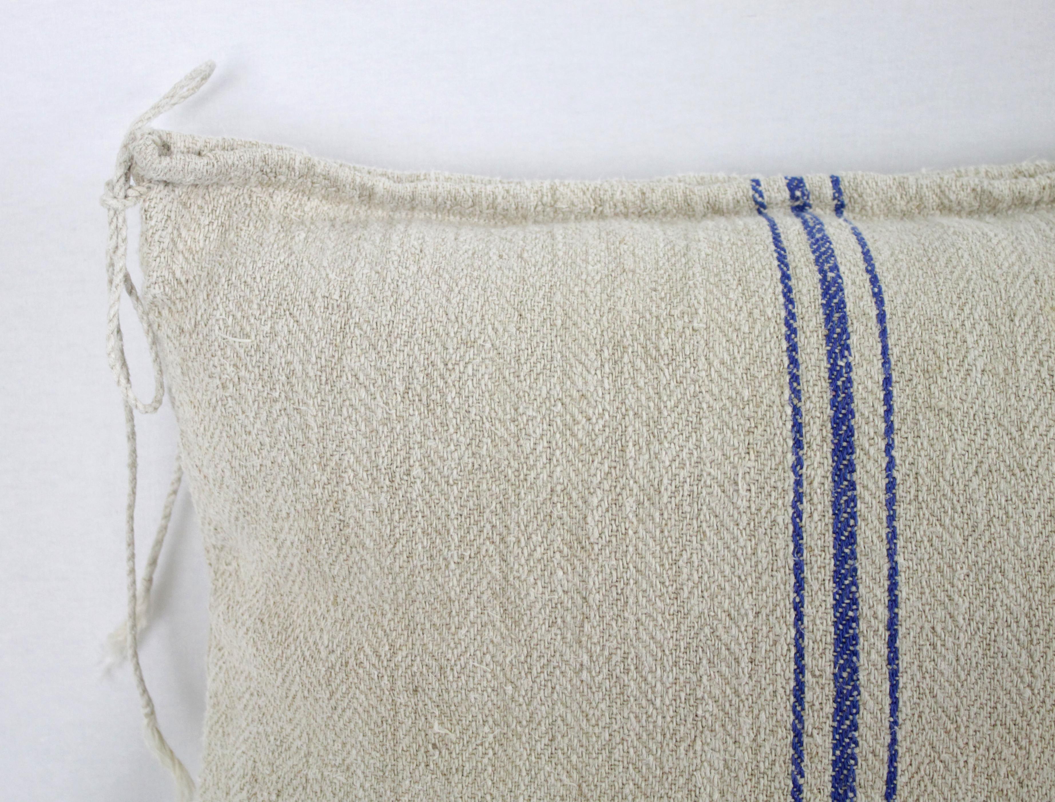 Beautiful pillow made from antique farmers grain sack, circa 1890-1920. These are a light oatmeal color with three small blue stripes in the centre. Each pillow is finished with a zipper closure. Front and back are in the same grain sack, and both