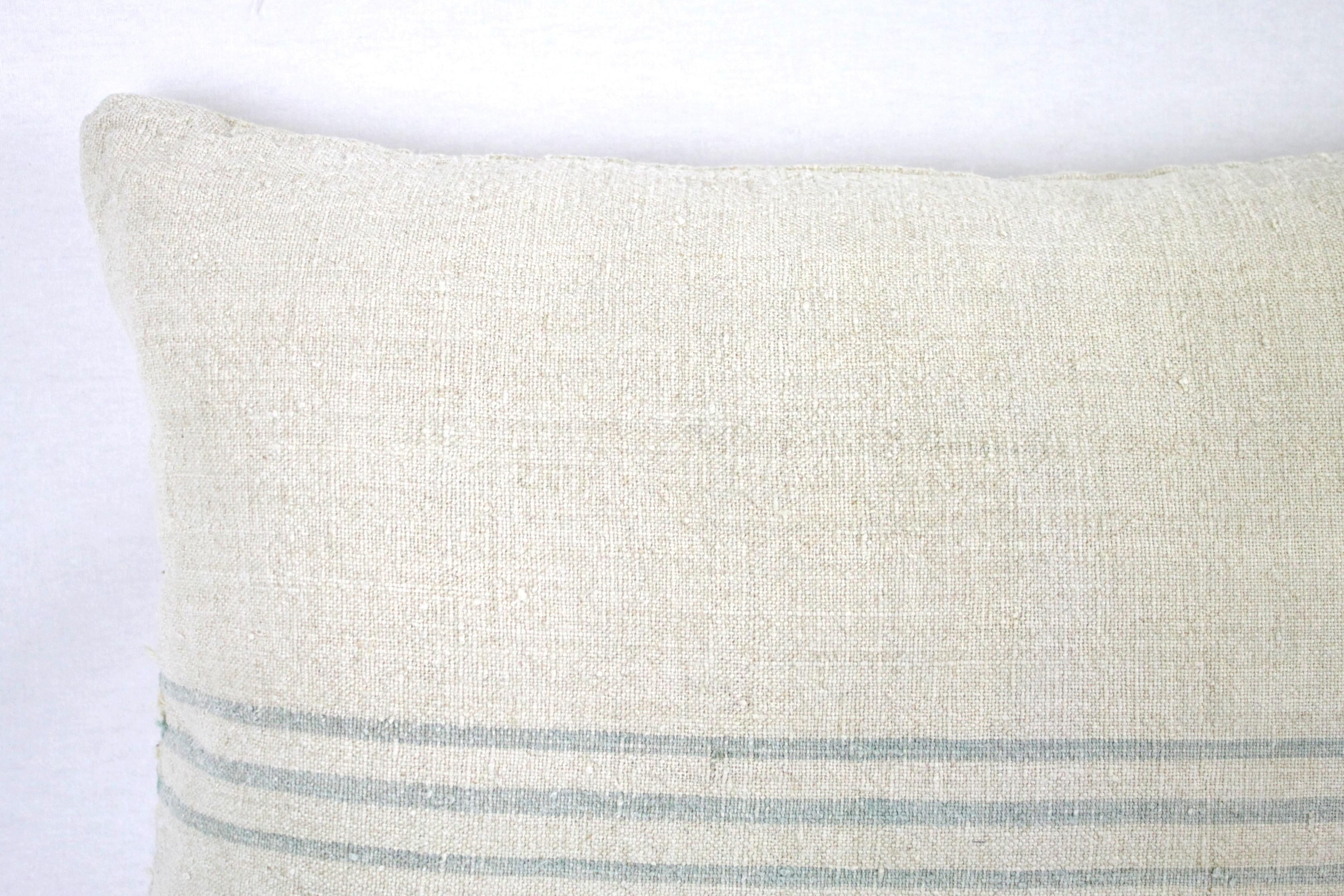 Beautiful pillow made from antique farmers grain sack, circa 1890-1920. These are a light oatmeal color with three small green/grey stripes in the centre. Each pillow is finished with a zipper closure. Front and back are in the same grain sack, and