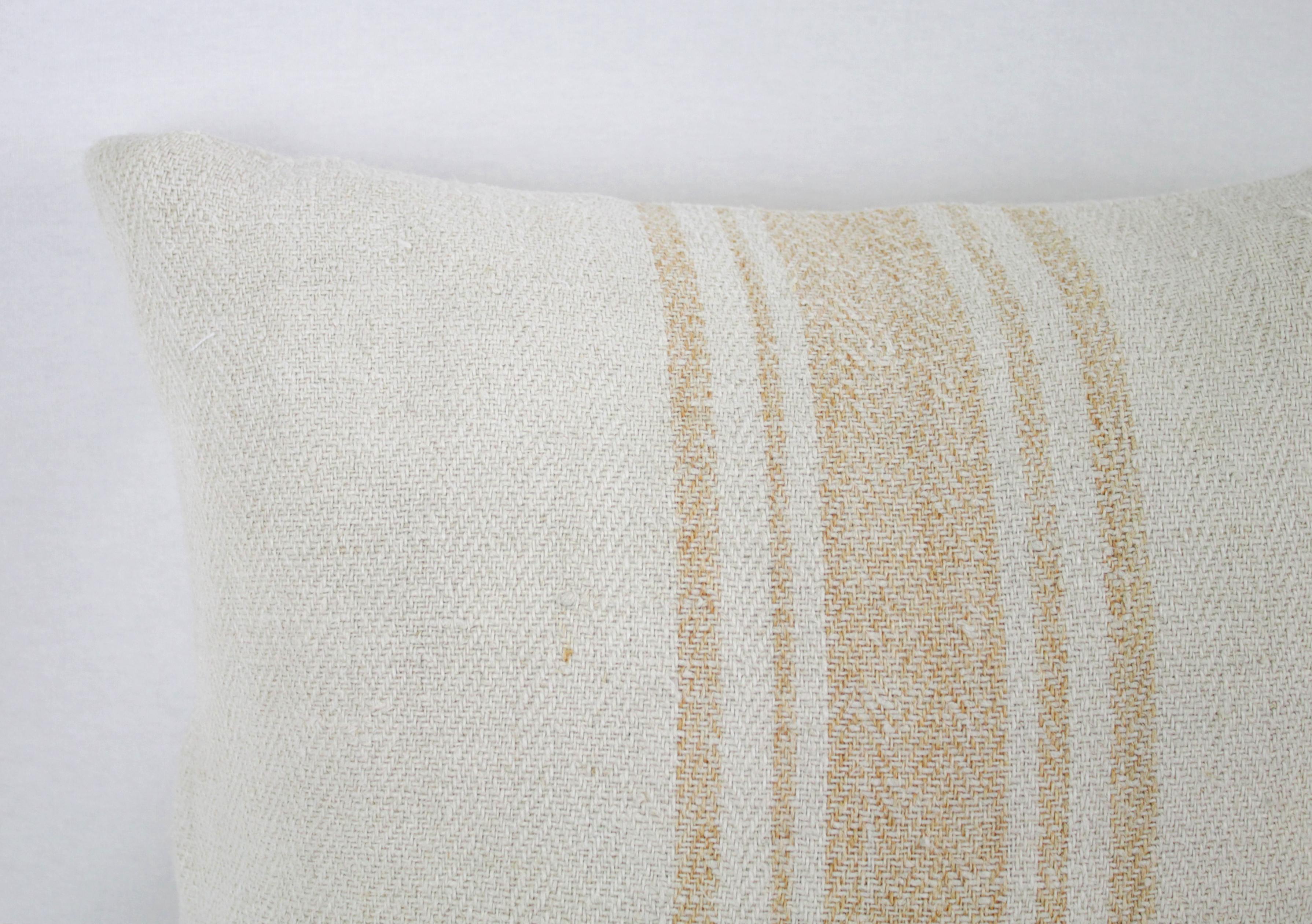 Beautiful pillow made from antique farmers grain sack, circa 1890-1920. These are a light oatmeal color with five orange stripes in the centre. Each pillow is finished with a zipper closure. Front and back are in the same grain sack, and both are