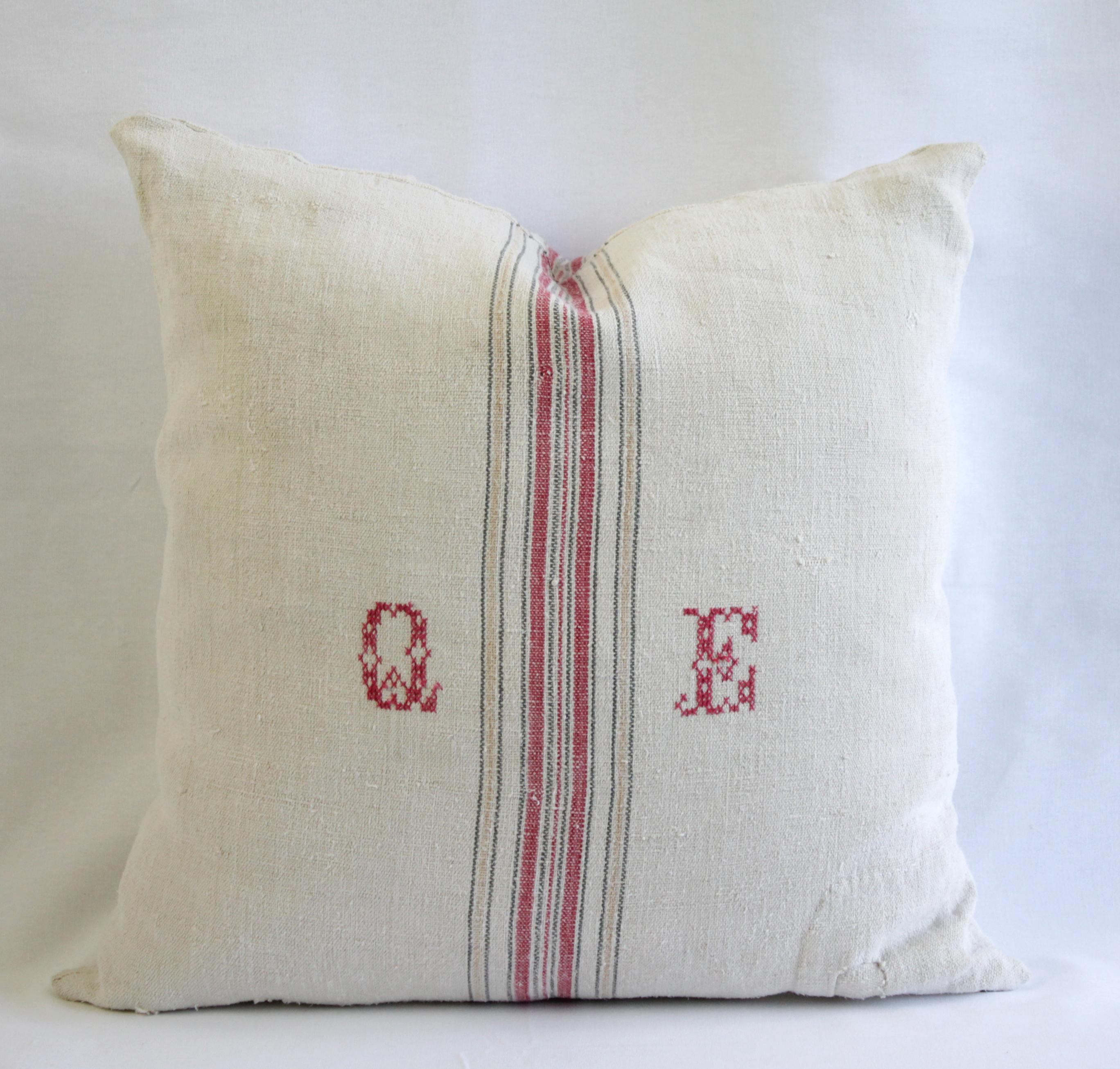 Beautiful pillow made from antique farmers grain sack circa 1890-1920. These are a light oatmeal color with a red and tan stripes in the center. This pillow has a monogram of 