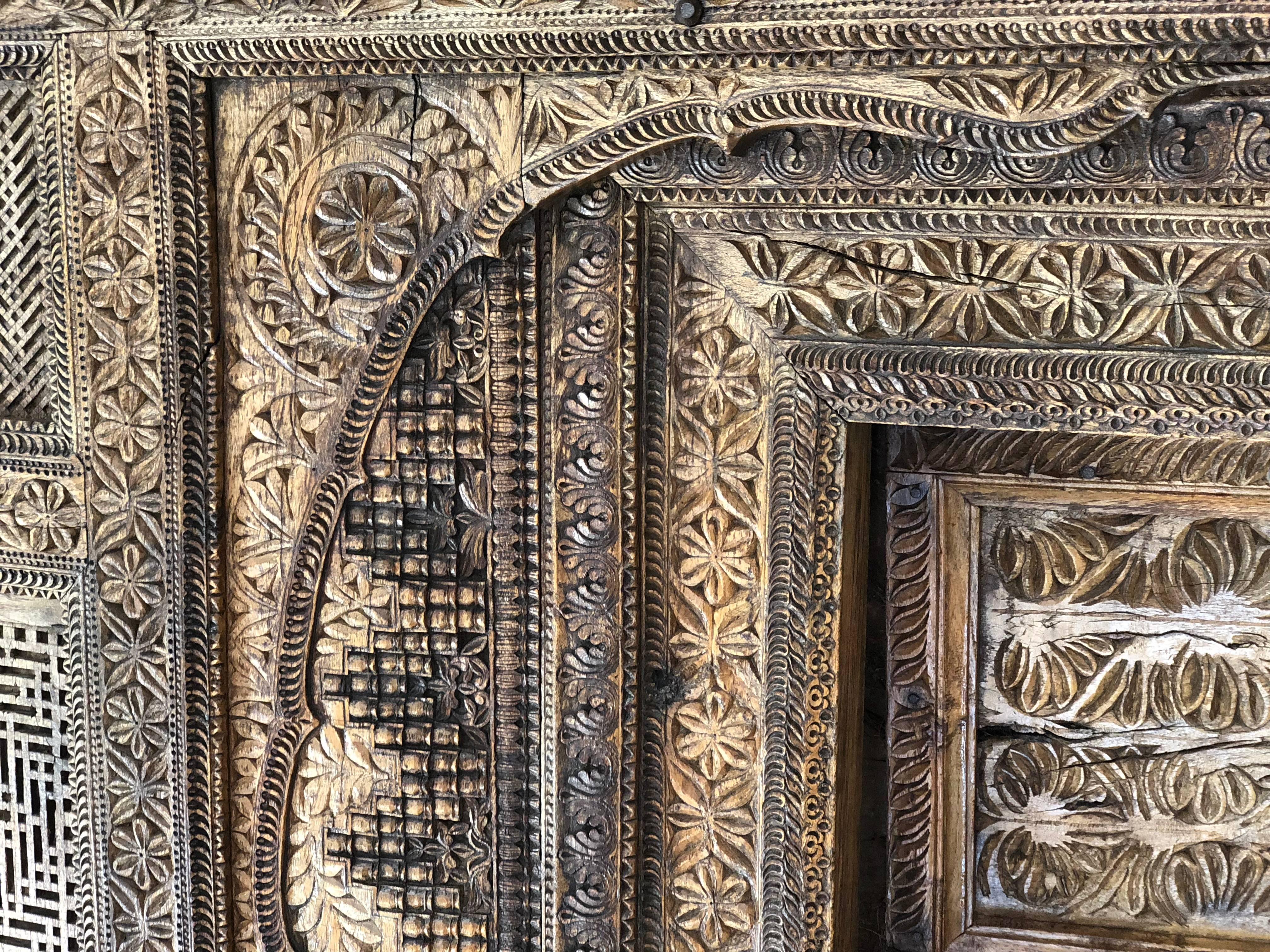 Afghan wooden entry door with columns and capitals
This beautiful doorway was imported from Afghanistan. Covered in decorative carved motifs, this double doorway would make a grand entry for a garden or compound. The assorted pillars, turned on