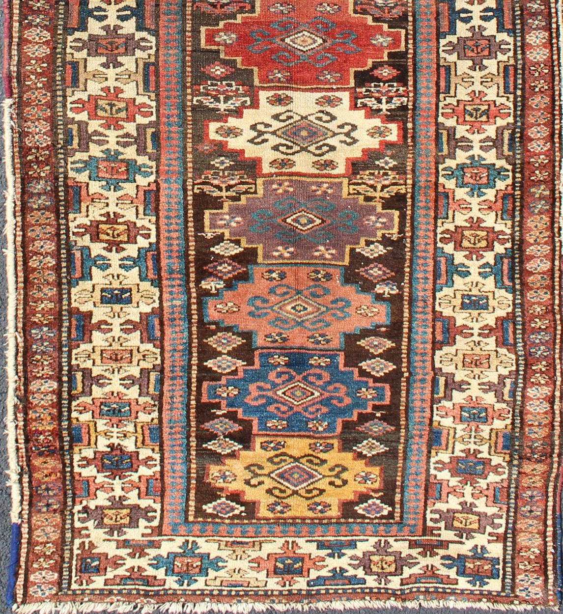 Northwest Persian antique runner with geometric design in multicolored tones, rug zir-12, country of origin / type: Iran / N.W. Persian Tribal, circa 1900.

This jewel-toned antique N.W. Persian rug, circa 1900, features a unique blend of colors