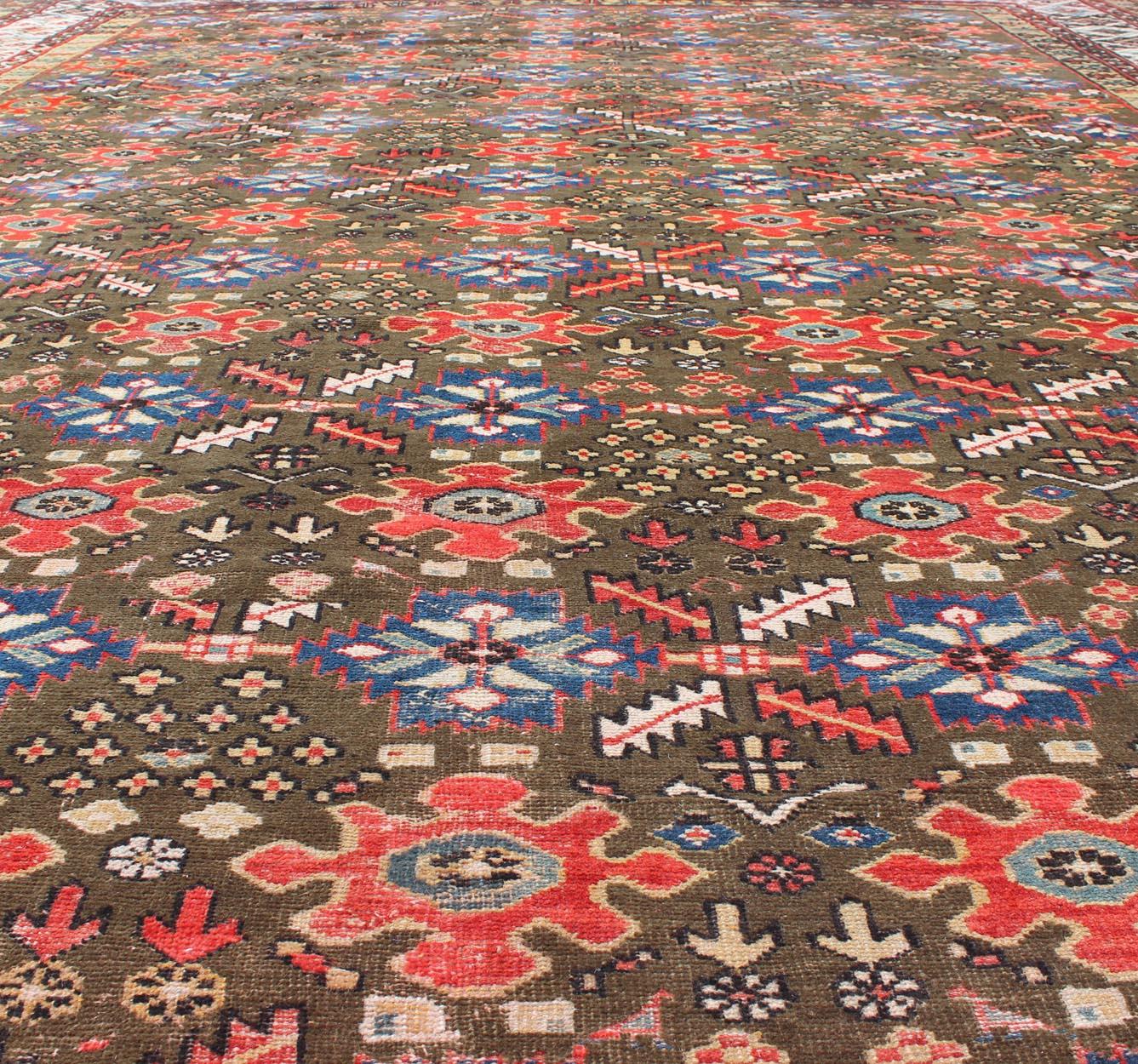 Wool Large Antique Kurdish Rug with All-Over Design in Brown/Green, Red, and Blue For Sale