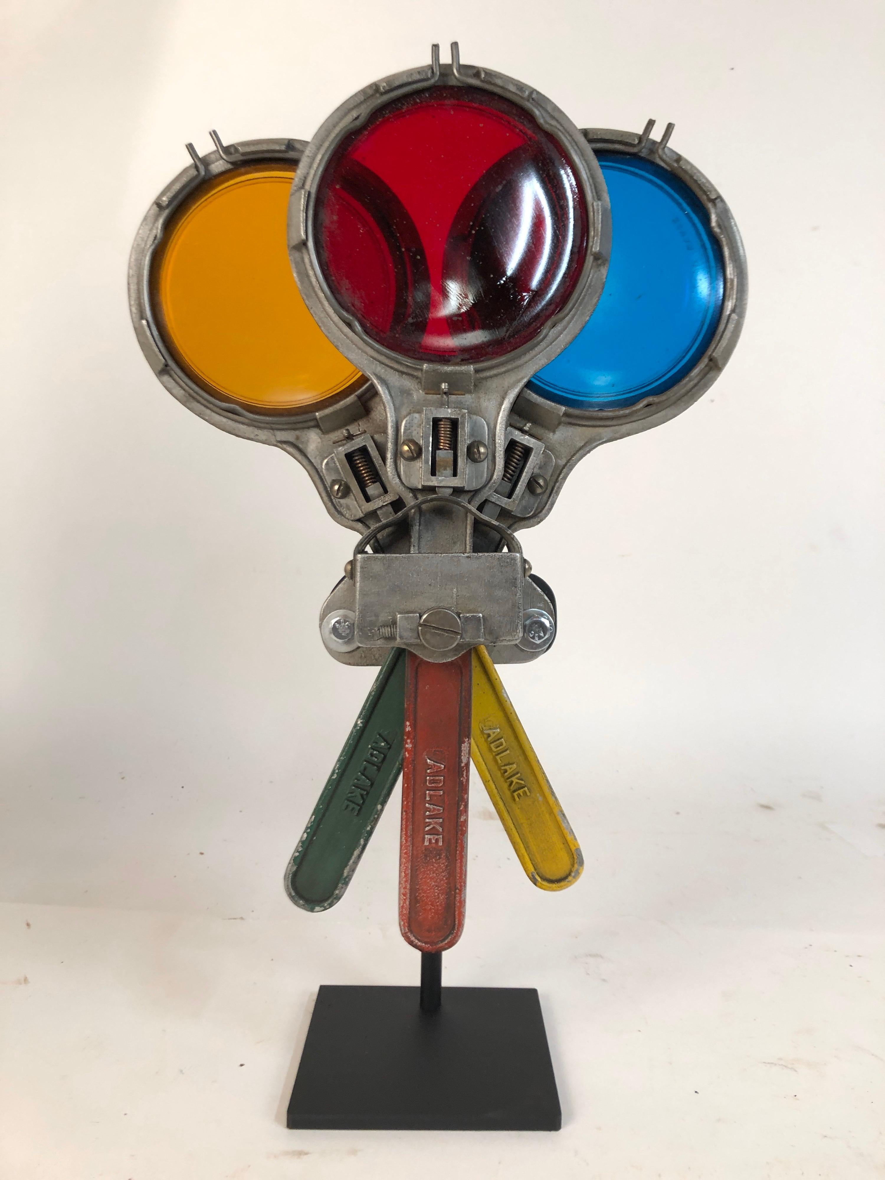A circa 1940s antique New York City subway semaphore. Three glass colored lens. Yellow, red and green. Mounted on a custom steel stand. Arms can be adjusted several ways. Total height 16