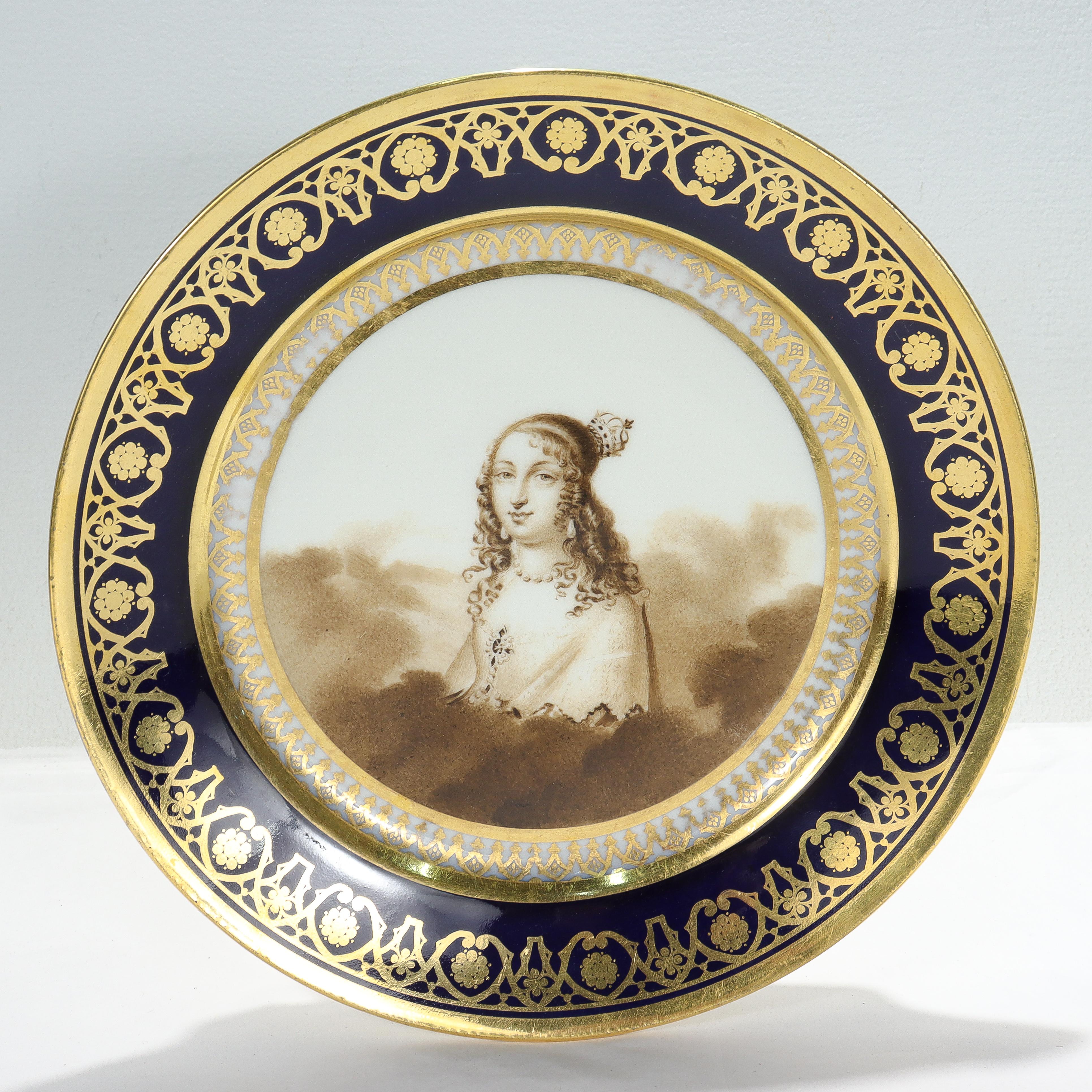 A fine antique Nyon Swiss hand painted porcelain cabinet plate with cobalt blue rim.

With a richly gilt cobalt border & decorated to the center with a hand painted portrait of a lady with crown amongst clouds in sepia tones.

Marked with the