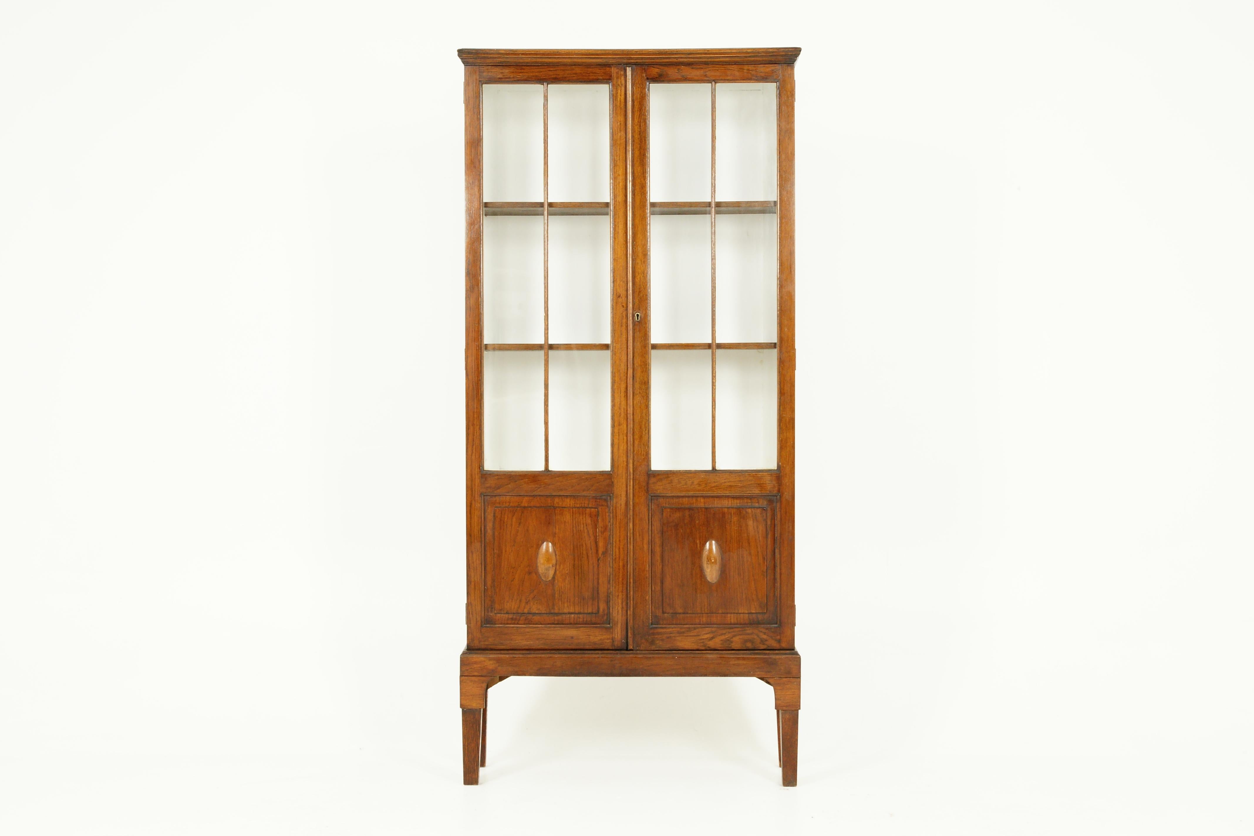 Antique oak 2 door bookcase, display cabinet, Scotland 1920, B2338

Scotland 1920
Solid oak
Original finish
Moulded Top
Pair of doors with glass on the top and the bottom having a paneled front
When opened the top section has a pair of