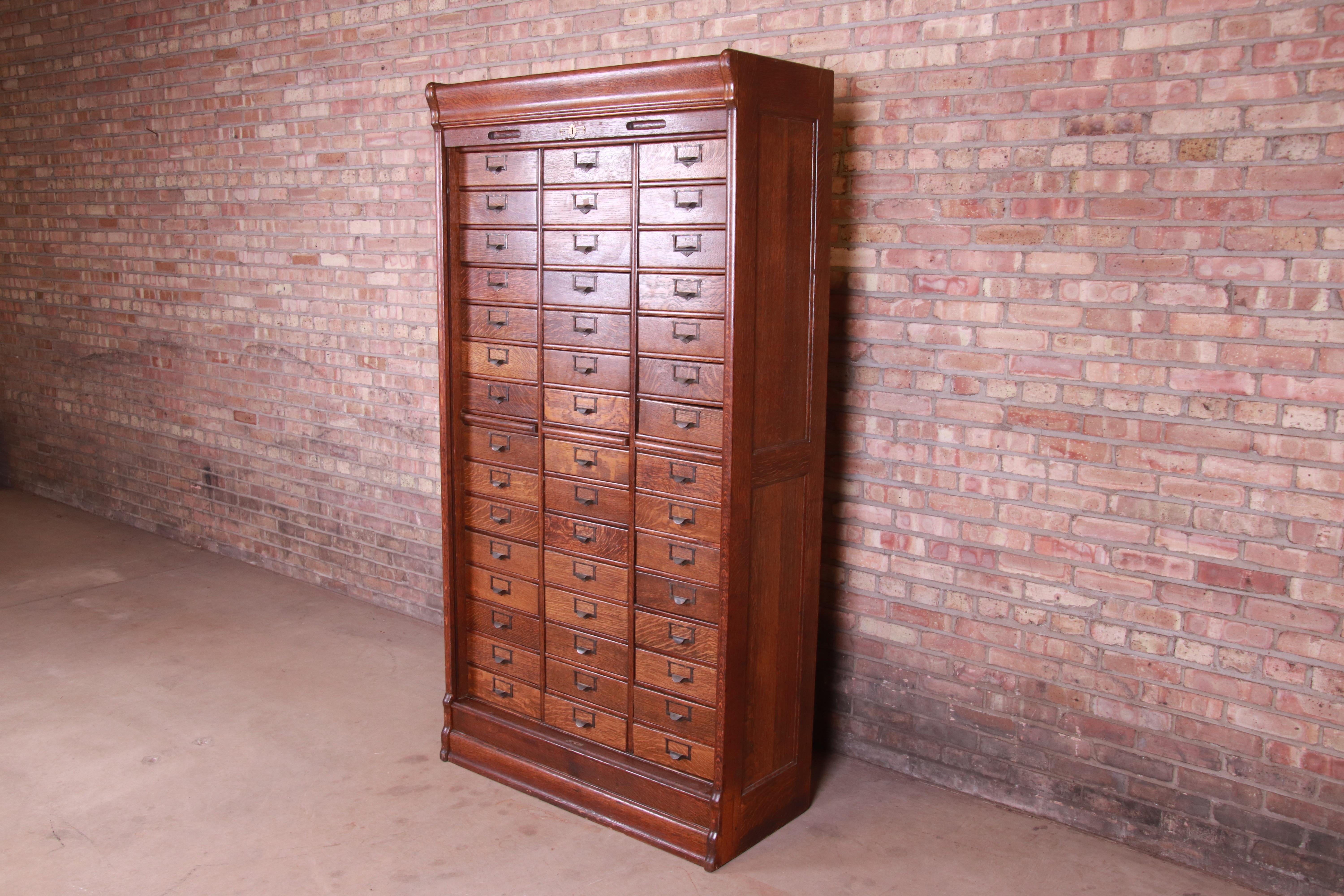 A rare and exceptional antique oak 45-drawer card catalog or file cabinet with roll down tambour door,

USA, circa 1900

Quarter sawn oak, with brass hardware.

Measures: 42