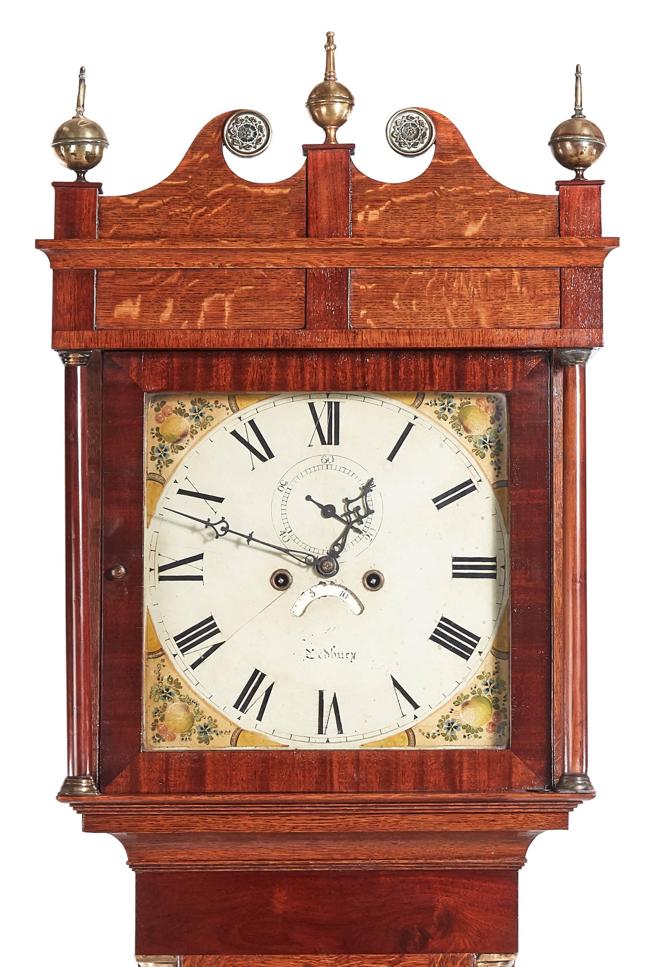 Antique oak 8 day longcase clock, with a swan-neck pediment, three original brass finials, lovely oak case crossbanded in mahogany, brass capped columns, standing on shaped bracket feet,8 day movement striking on a bell, attractive painted dial, all