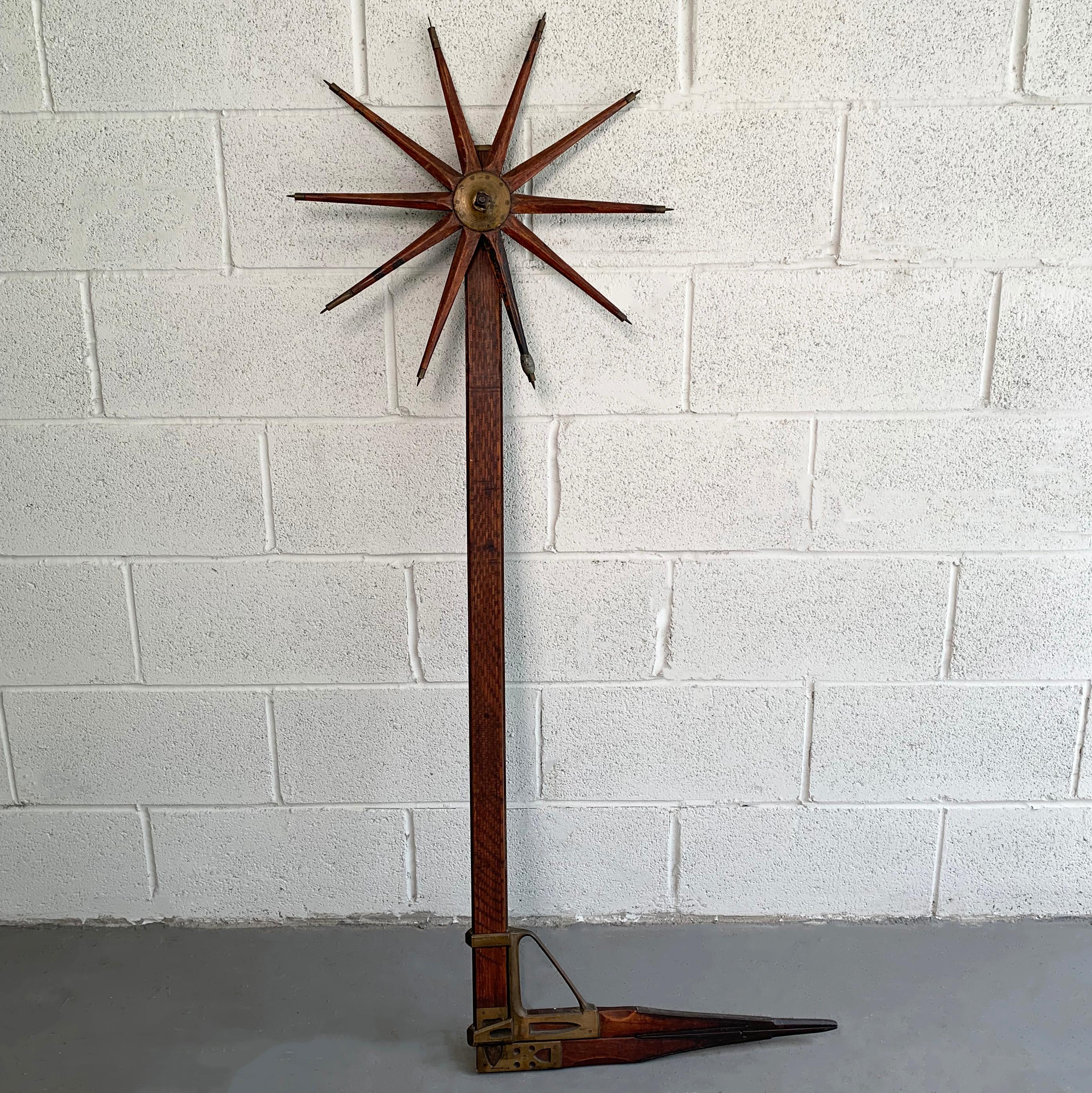 Turn of the 20th century, oak and handcrafted brass, lumber caliper by William Greenlief used to measure the amount of timber from a tree features a sliding caliper and spiked walking wheel.