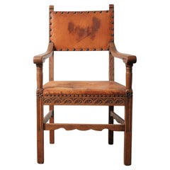 Antique Oak and Leather Armchair with Decorative Carving and Brass Nailhead Trim