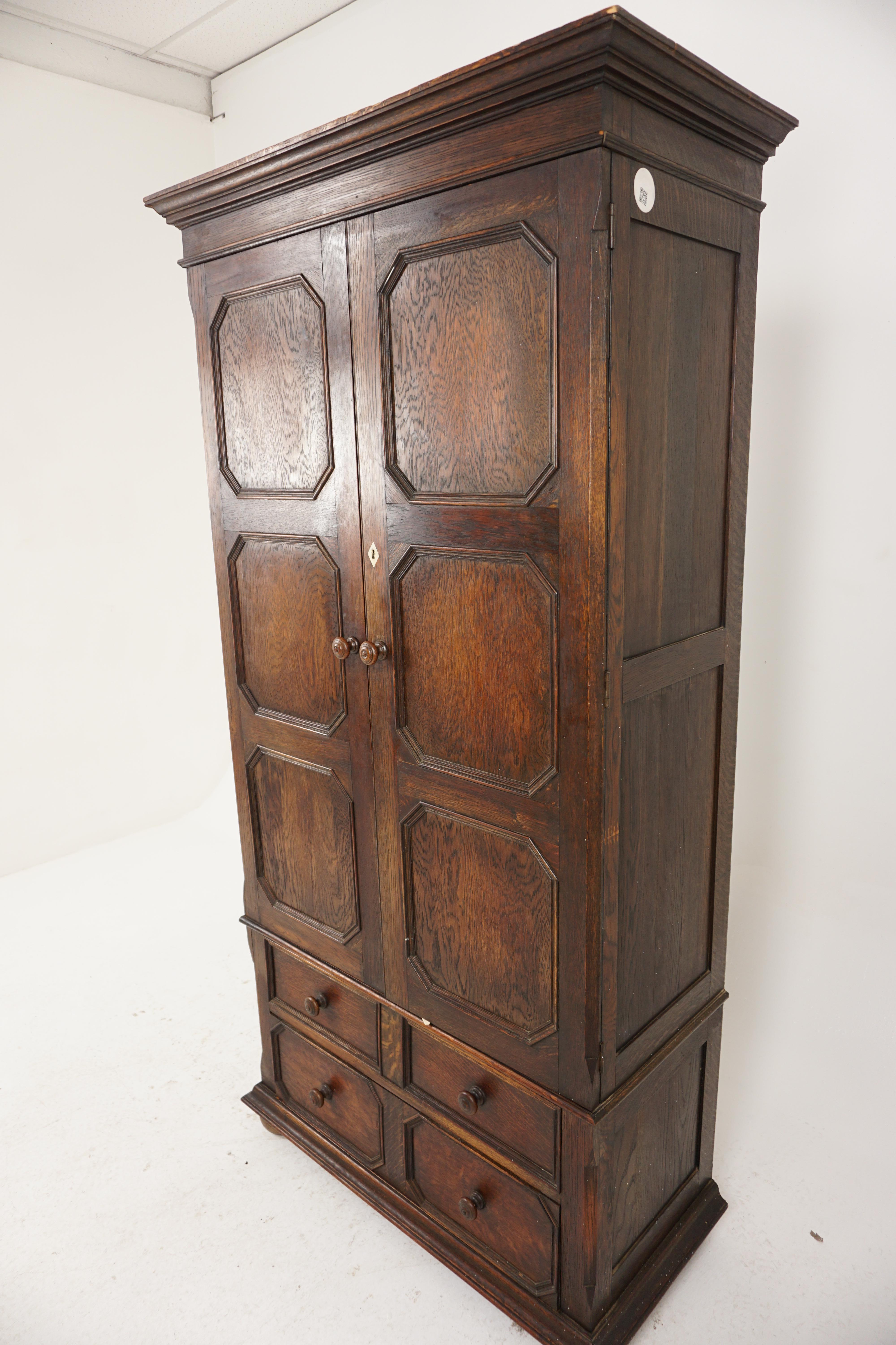 Antique Oak Armoire, Hall Cupboard, Wardrobe, Heal & Son London, England 1910, H1043

England 1910
Sold oak
Original finish
Moulded cornice on top
With a pair of panelled doors with wooden knobs and a bone escutcheon
Opens to reveal brass hooks and