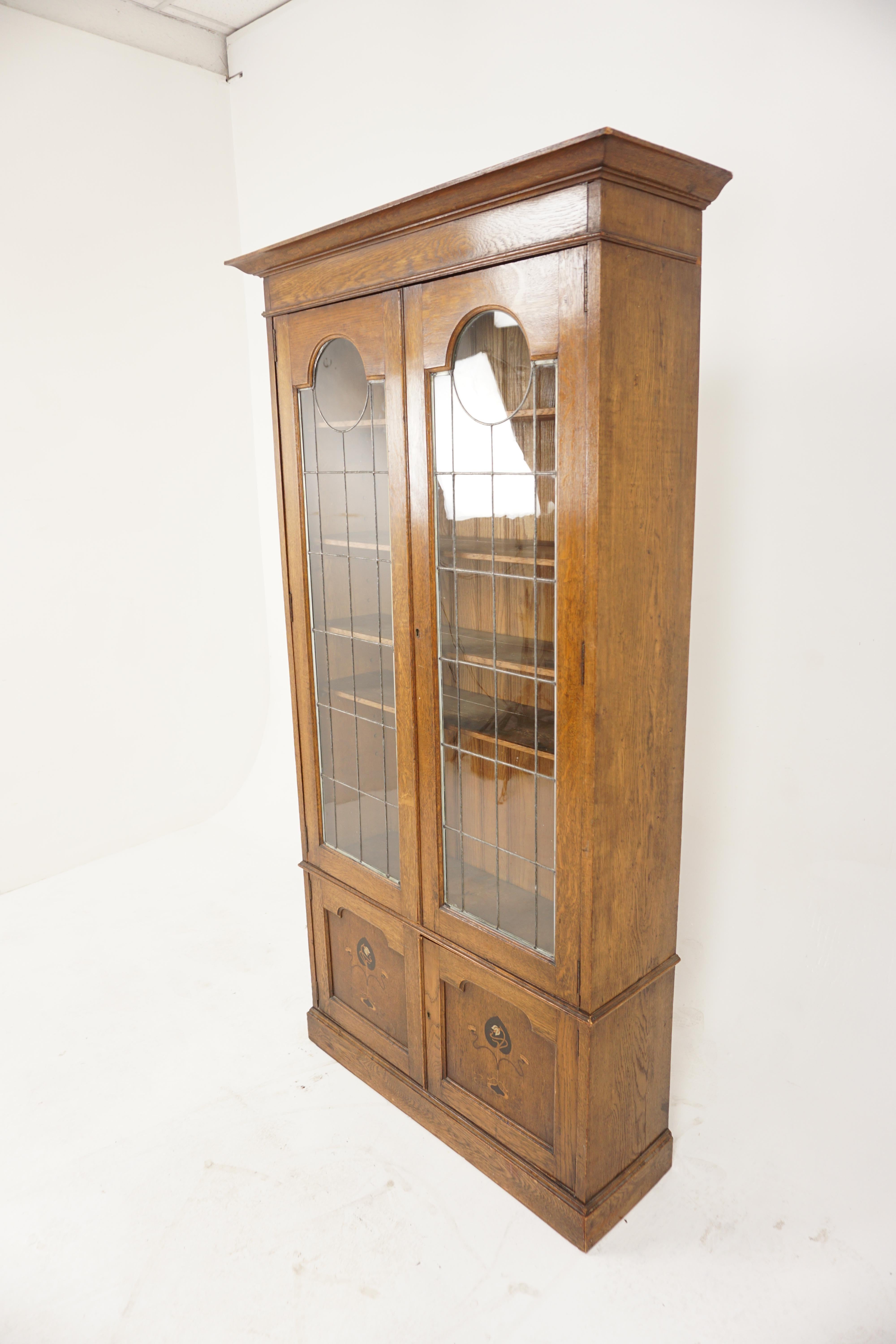 Antique Oak Art Nouveau, Arts & Crafts Inlaid, Leaded Glass Bookcase, Display, Scotland 1900, H1163 

Solid Oak
Original Finish
With Projecting Moulded Cornice
A pair of leaded glass doors open to reveal four adjustable shelves
Pair of inlaid