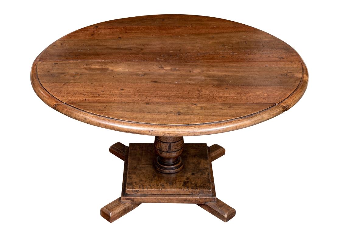 An interesting and very well made low oak pedestal table, with ringed incised baluster form pedestal, surmounting a stepped square wood base resting on four splayed legs. Suitable as Cocktail. End or Low Center Table. 

Dimensions: 21 1/2