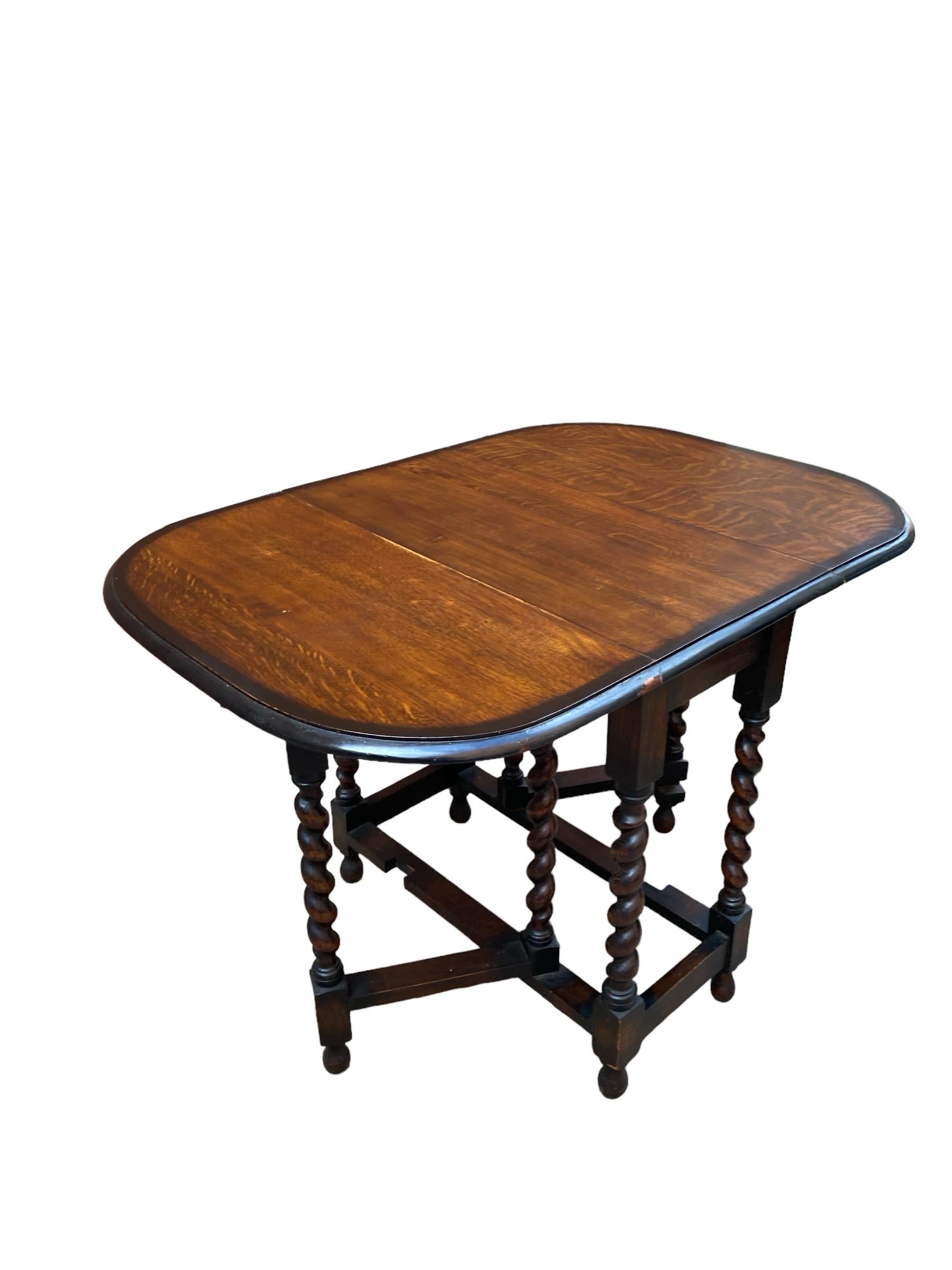 Antique Oak Barley Twist Drop Leaf Gate Leg Table, late 19th Century, Mid coloured Oak with and unusual ebonised edge to the top. Beautifully carved barley twist legs that swing out to make three different sizes folding to a small size when out of