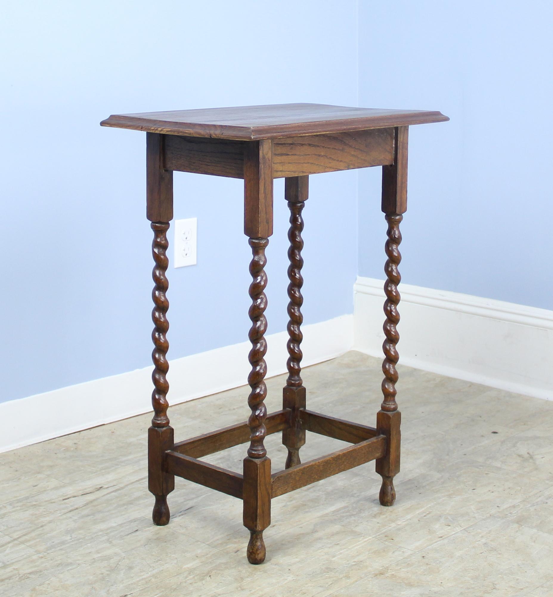 A charming simple occasional table in dark oak with eye-catching barley twist detail. Would also make a nice lamp table and would pair well on either side of a sofa or guest bed with our other barley twist side table. While not identical, would pair