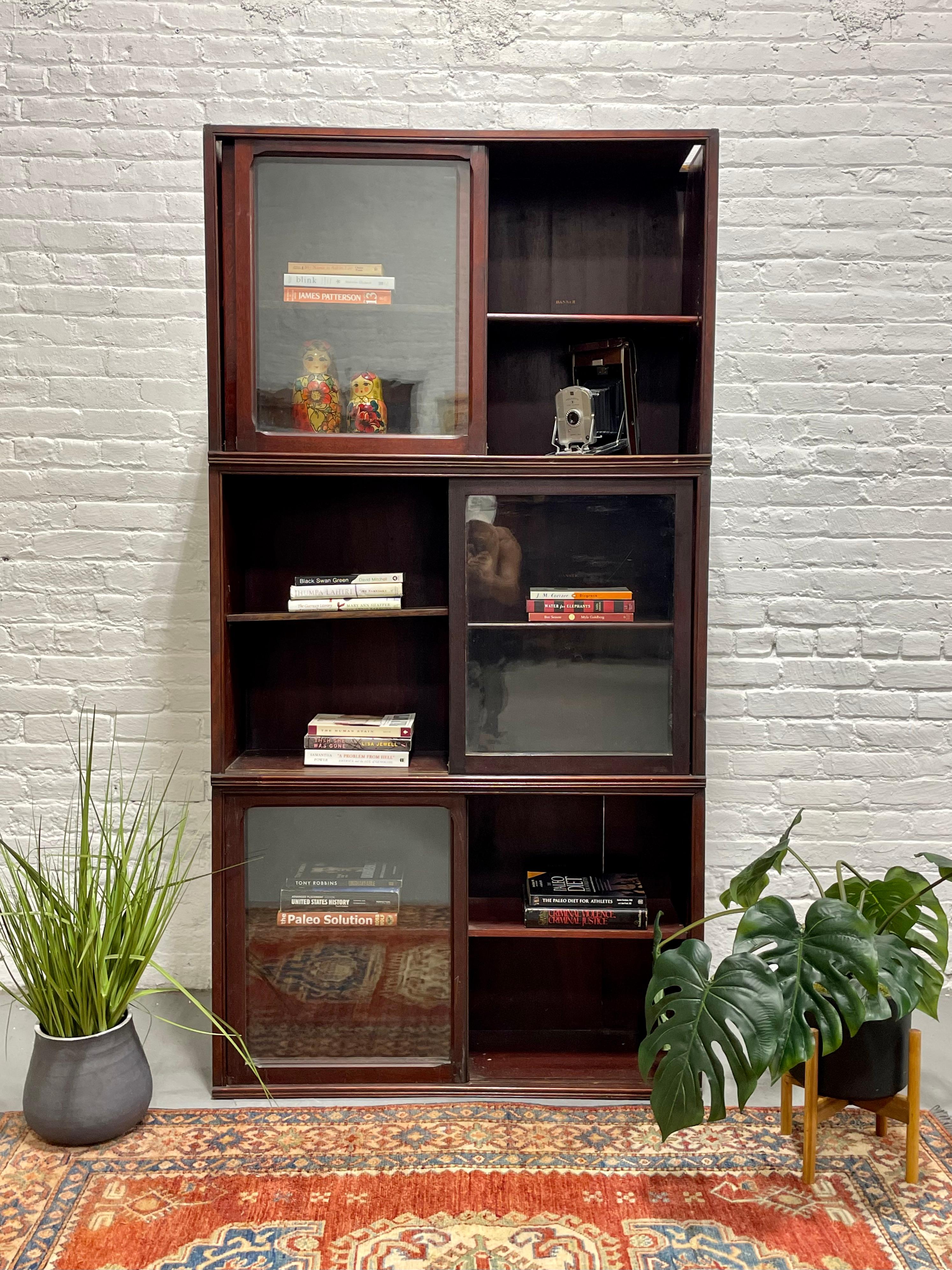 Antique Quarter Sawn Oak Barrister Bookcase / China Cabinet by Danner Furniture, c. 1910's. The bookcase is in three parts that sit atop one another. There are sliding glass doors in each cabinet as well as adjustable shelving. Good vintage