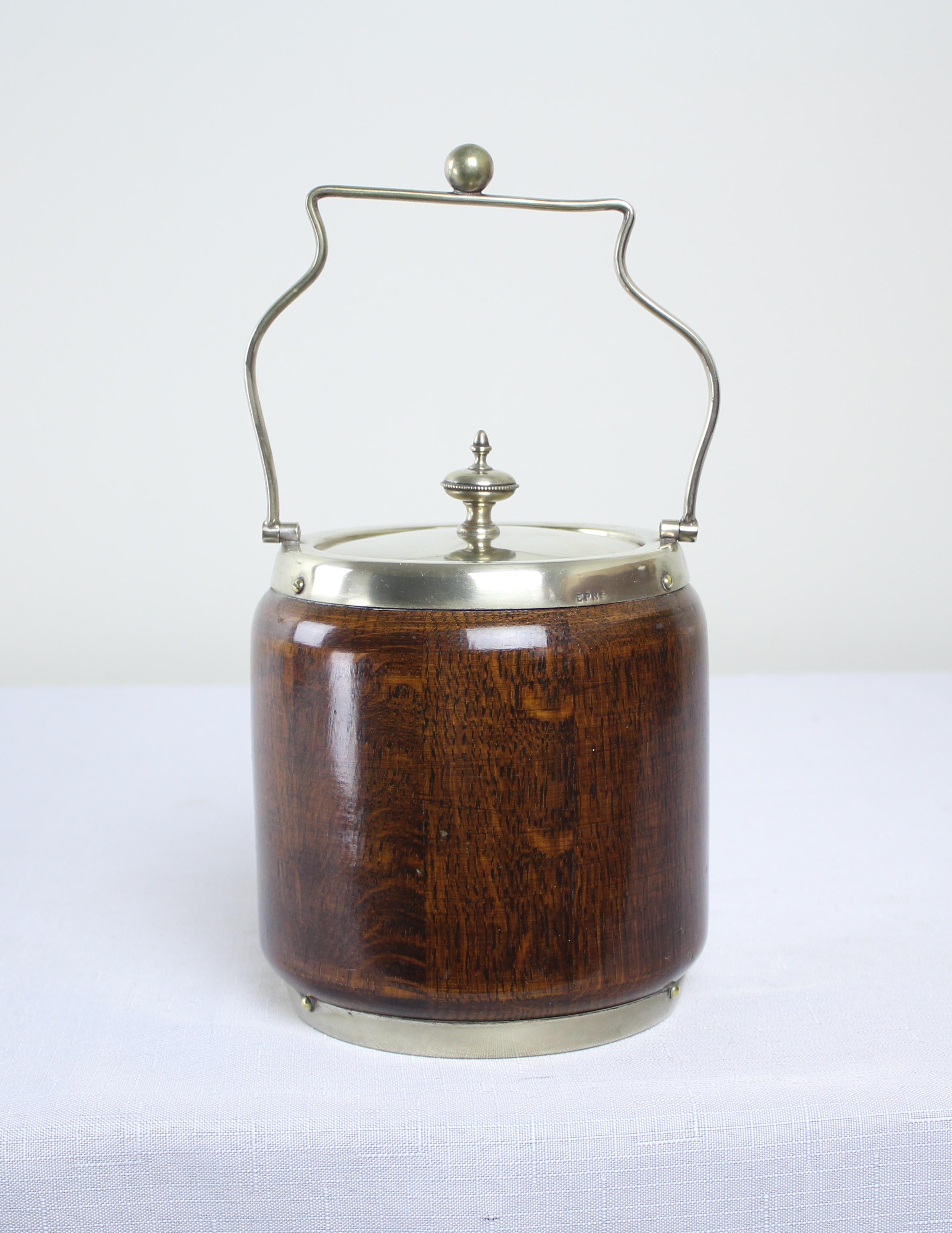A charming oak biscuit barrel from the late 19th century. The metal is stamped 