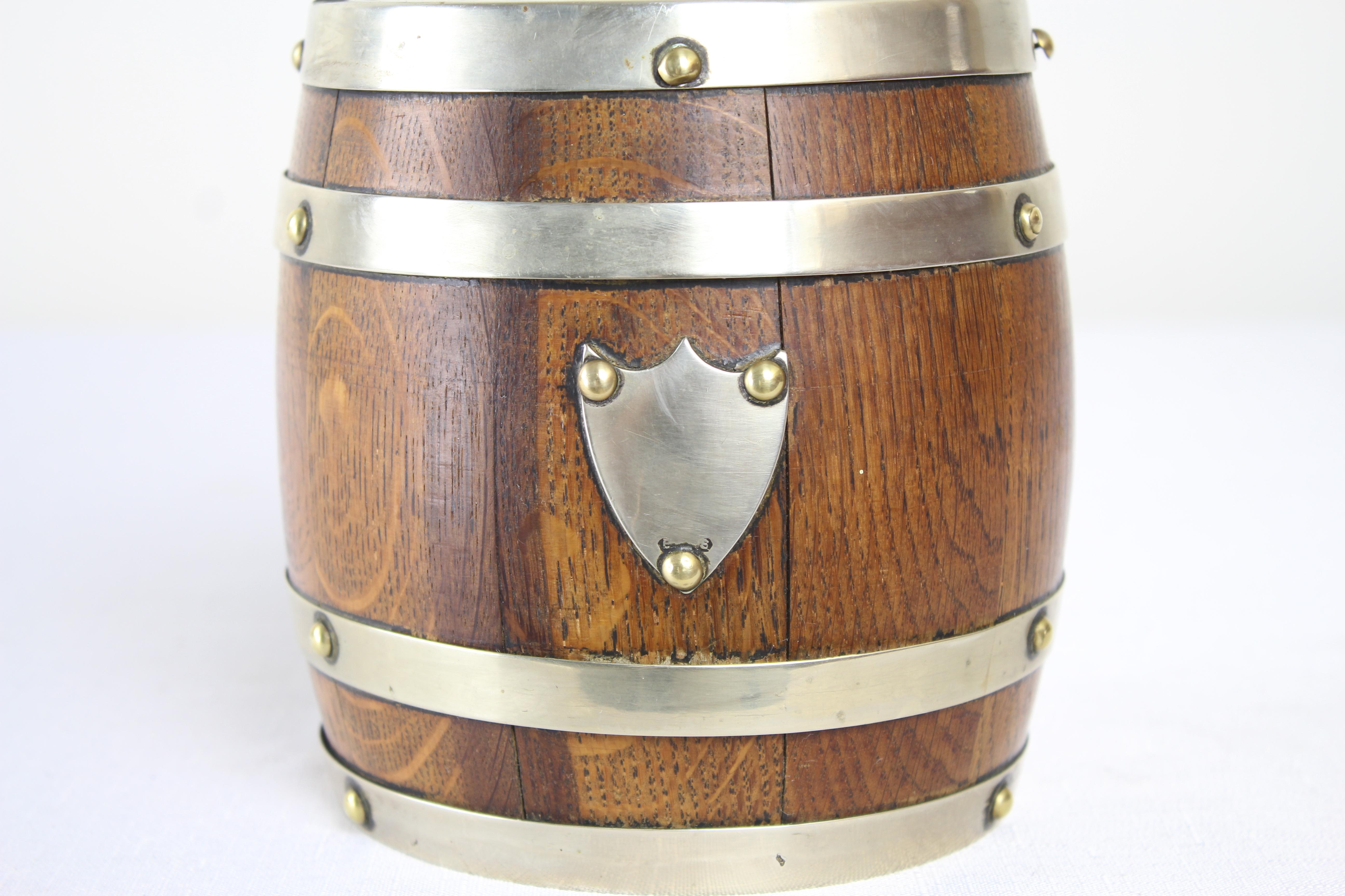 A charming oak biscuit barrel from the late 19th century. The metal is stamped “EPNS”, or Elecro Plated Nickel Silver, a metal alloy that is then silver plated. Traditional porcelain liner and sweet handle.