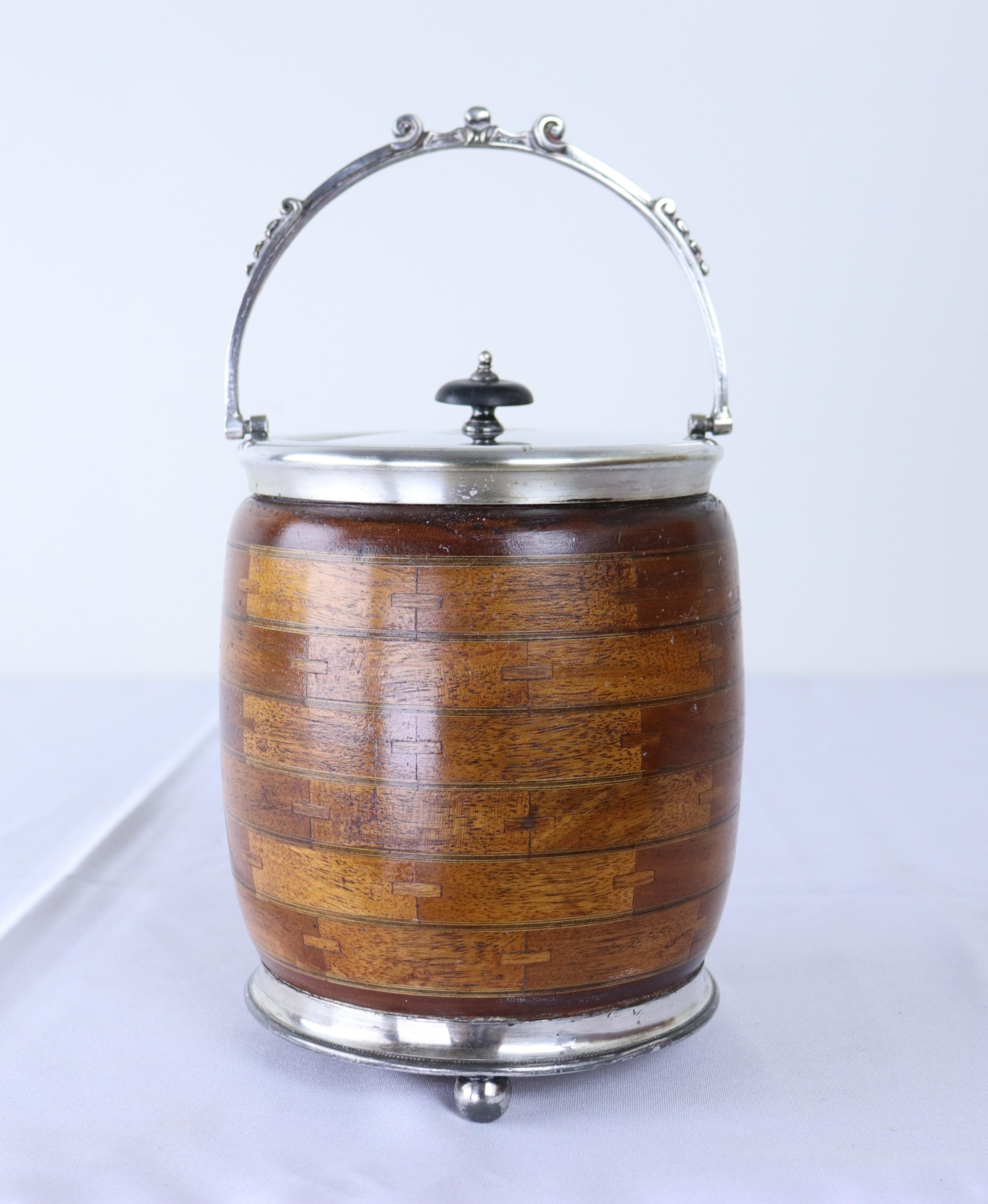 A charming oak biscuit barrel from the late 19th century. The metal is stamped 