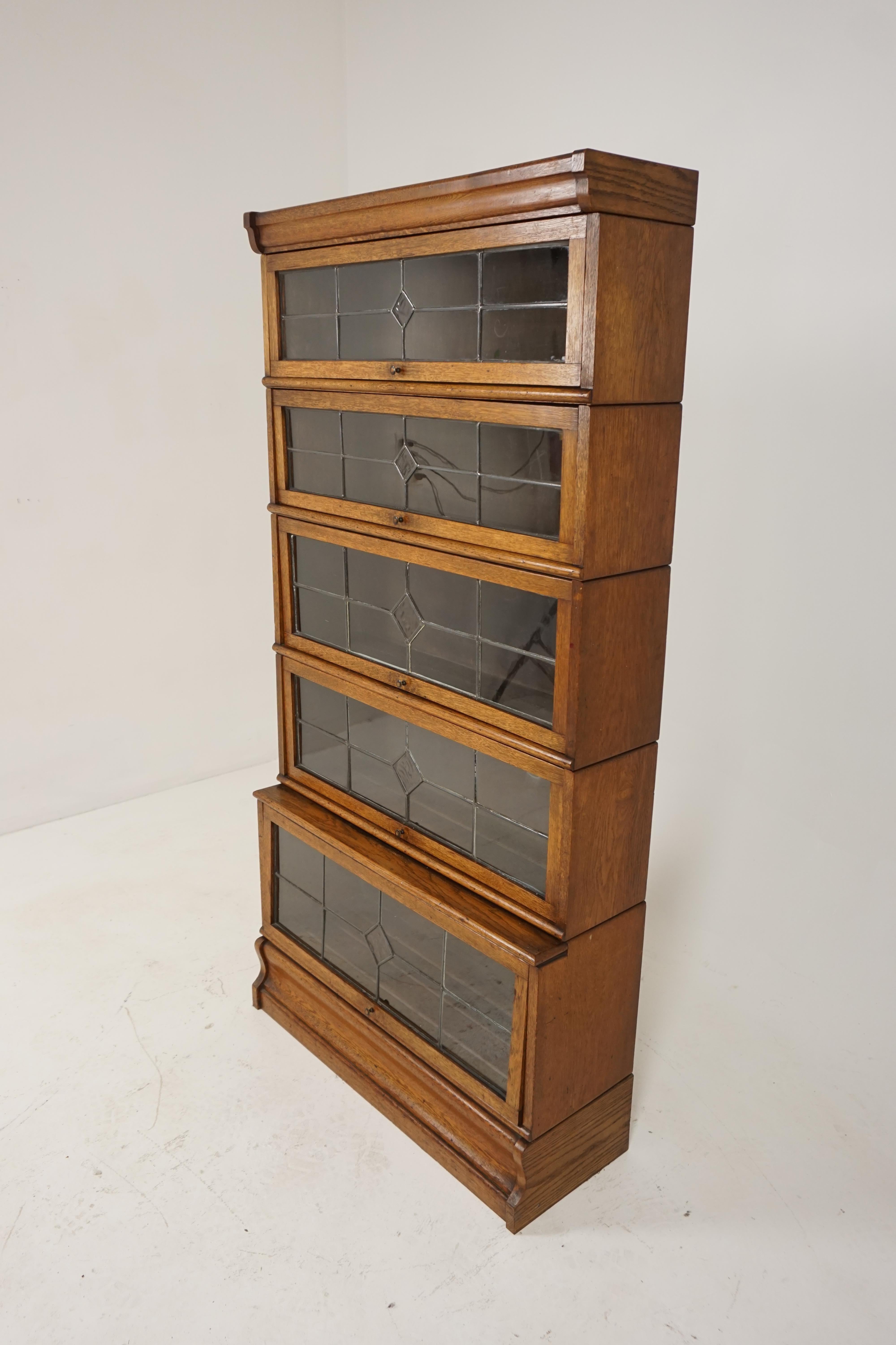 Scotland, 1920
Solid oak
Original finish
This is a Globe Werniche style
Comprising of five graduating sections all with moulded fronts
Original leaded glass on the front
Original copper knobs to the doors
The doors lift up and slide back into