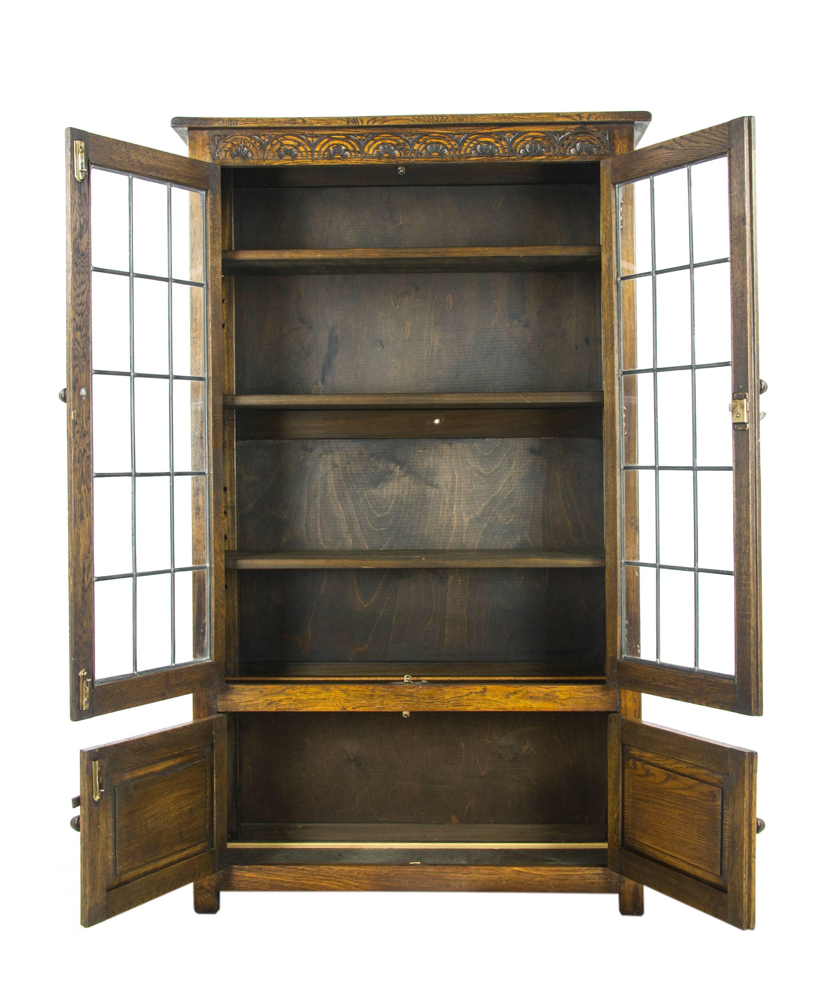 Antique Oak bookcase, antique bookcase, leaded glass bookcase, Scotland, 1930, antique furniture, B1069

Scotland, 1930
Solid oak construction
Original finish
Carved top above
Two leaded glass doors
Solid oak shelves
Pair carved paneled doors