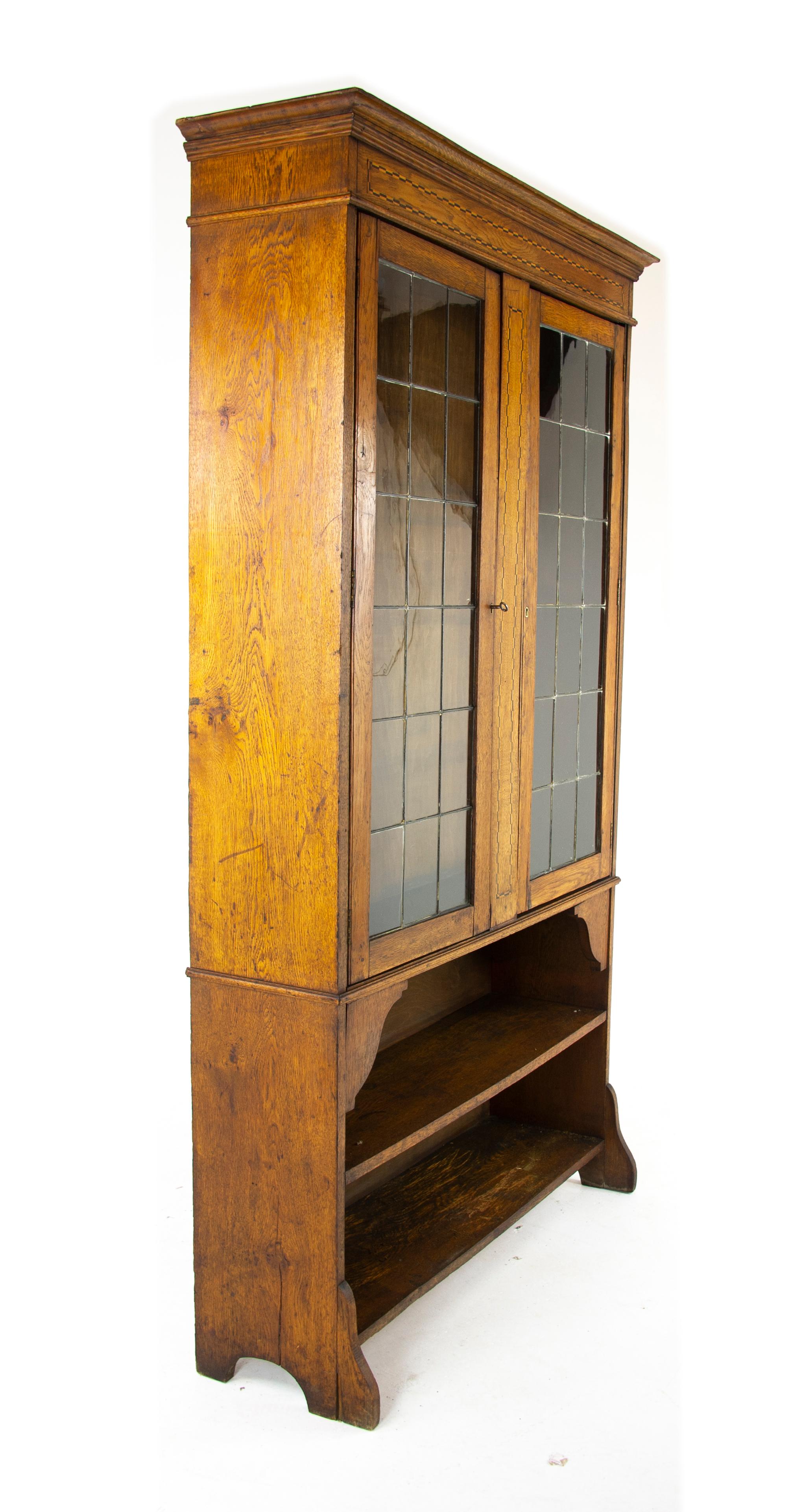 Antique oak bookcase, Arts & Crafts, inlaid bookcase, leaded glass doors, Scotland 1910, antique funiture, B1169A.

Scotland 1910
All original
Overhang cornice on top
Inlaid frieze below
Pair of leaded glass doors below
Centred by inlaid