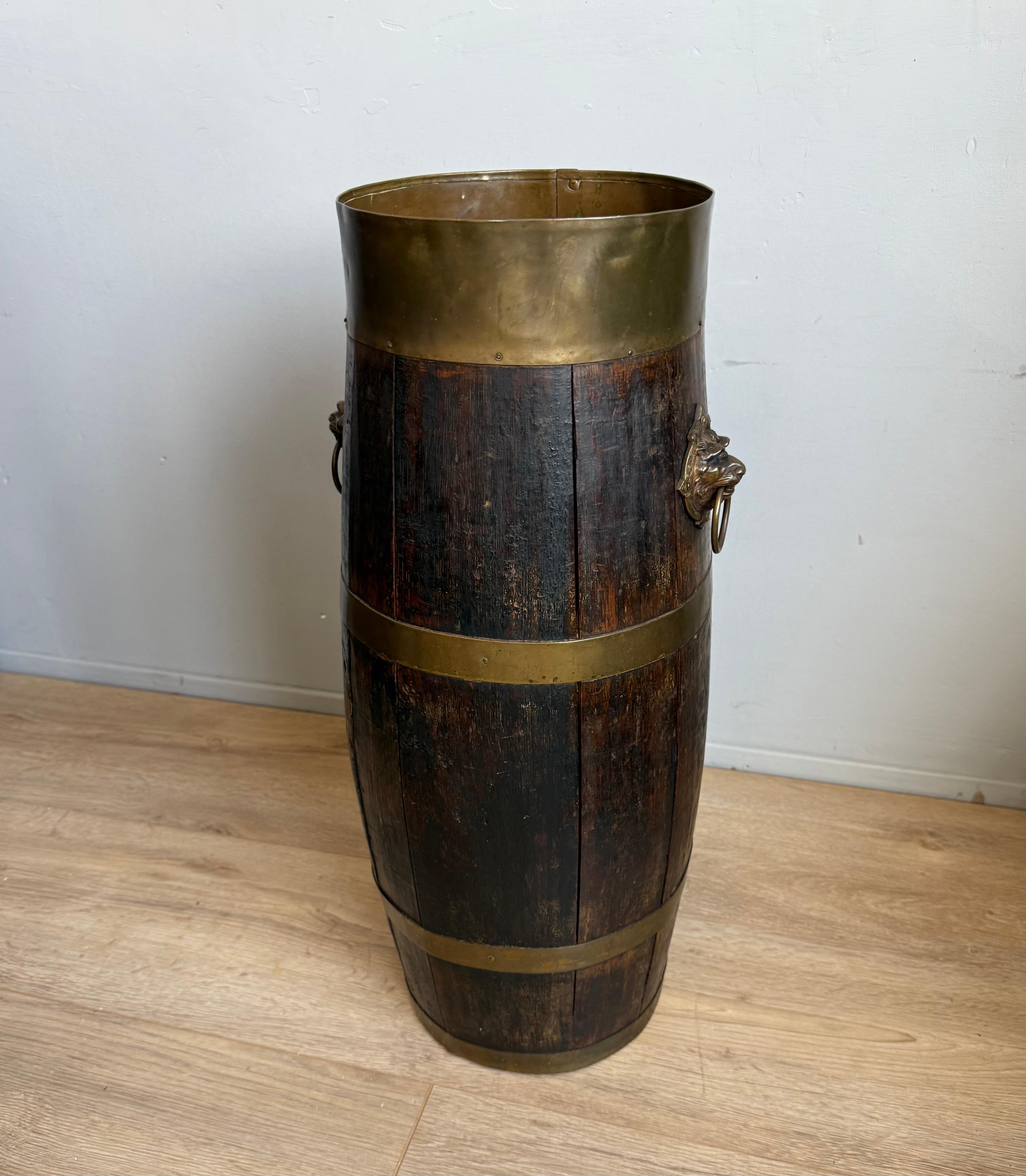 Antique long barrel umbrella or stick stand with bronze lion head handles.

This exquisite handcrafted umbrella or stick stand is a fine example of antique craftsmanship and elegant utility. Expertly constructed from solid oak, the tall