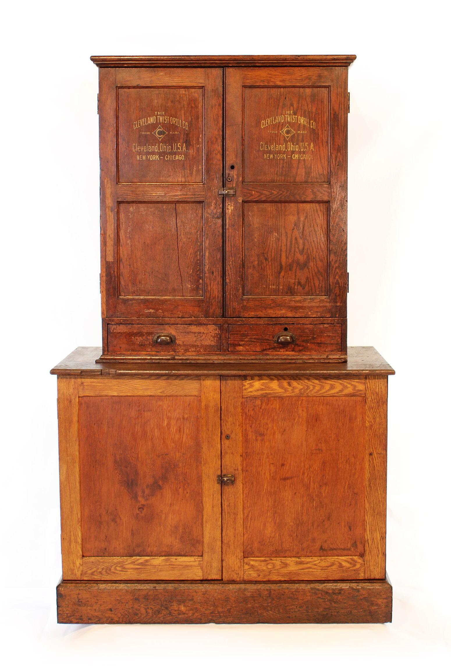 Authentic Cleveland Twist Drill oak machinist's cabinet used for storing drill bits and parts. Features brass hardware, 46 drawers, 52 cubby holes, oak drawer pulls, original reference charts on top inside doors. Has been lightly cleaned to preserve