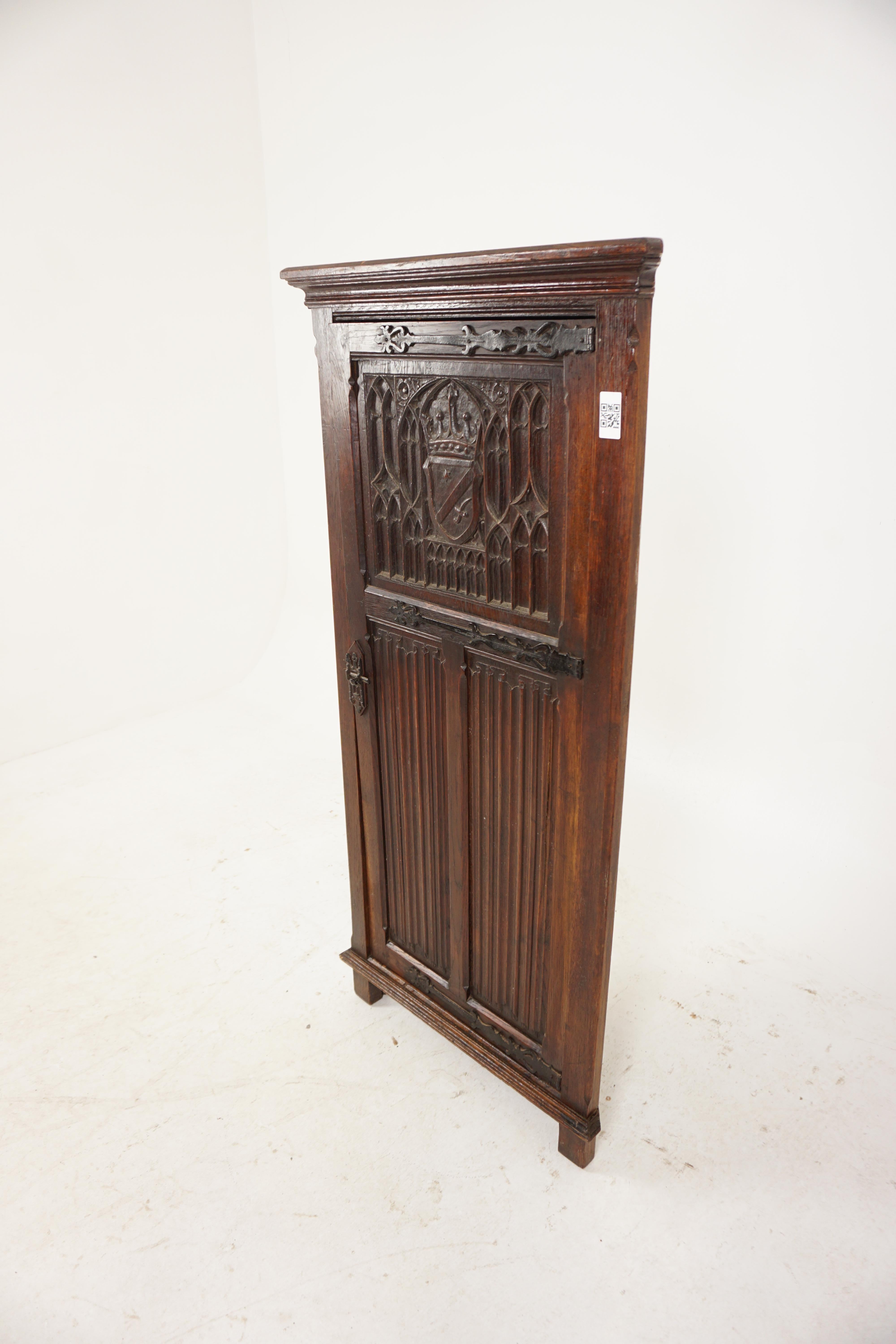 Antique Oak Cabinet, Carved Oak Gothic Style Corner Cabinet, Antique Furniture, Scotland 1900, H991
 
+ Scotland 1900
+ Solid oak
+ Original finish
+ Flared cornice on top
+ Single heavily carved panel door with carved crown
+ Shield top